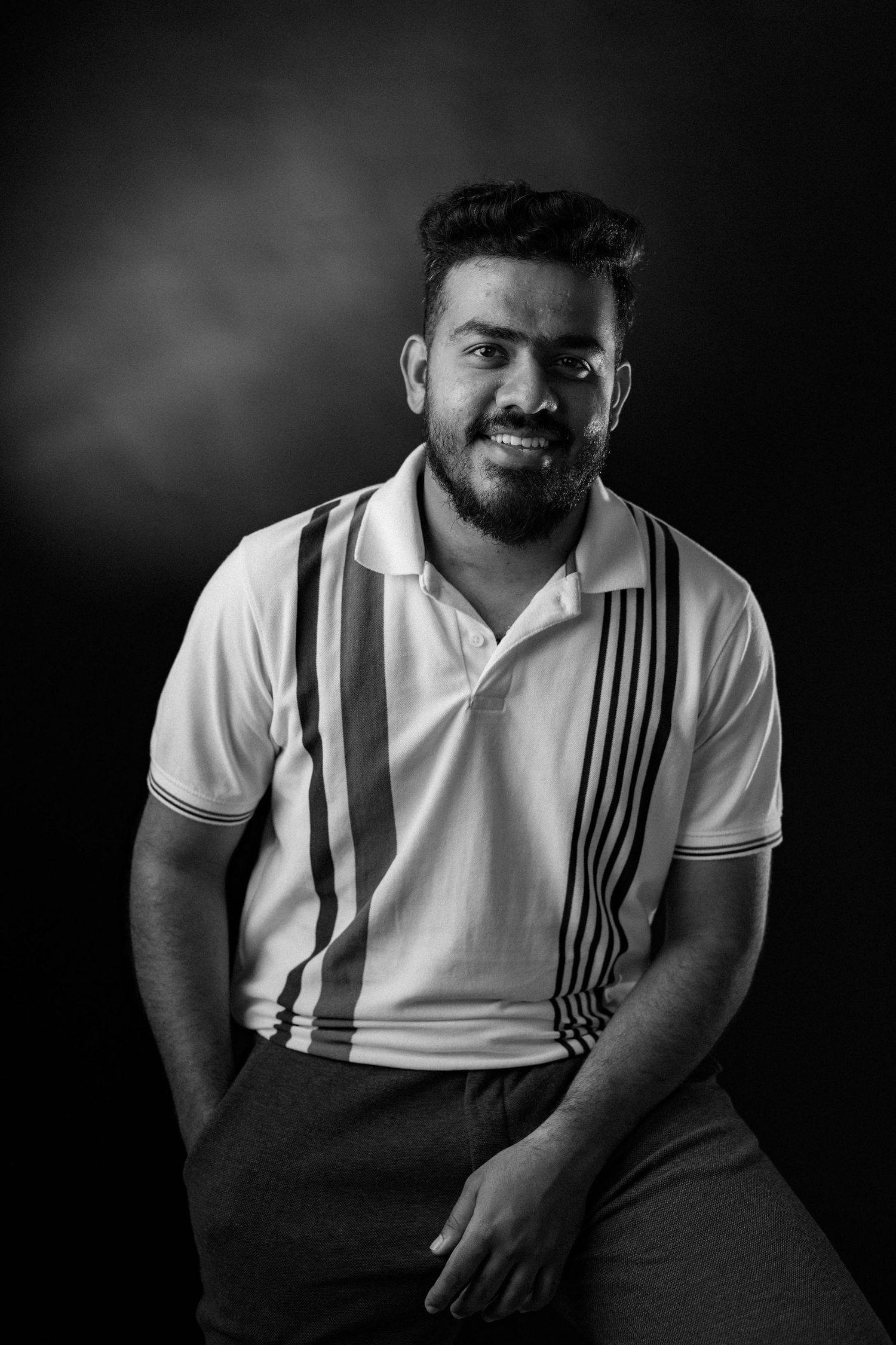 A series of black and white portraits showing a person in a white striped polo shirt against a dark background.