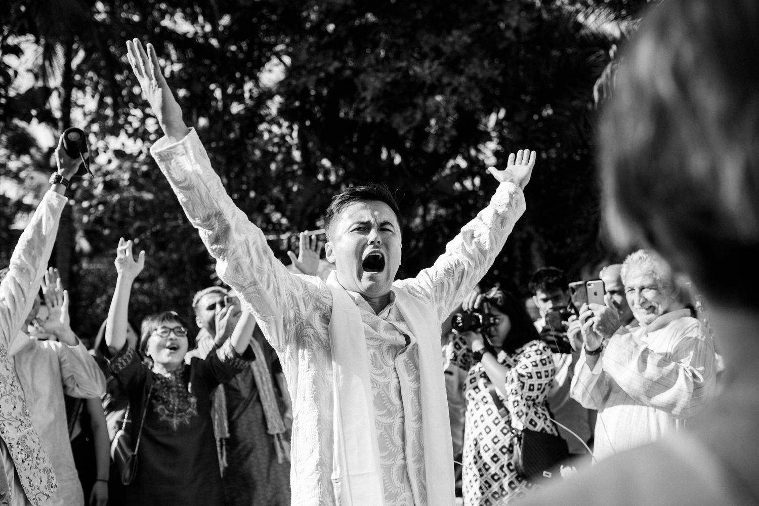A groom passionately shouting at his wedding.