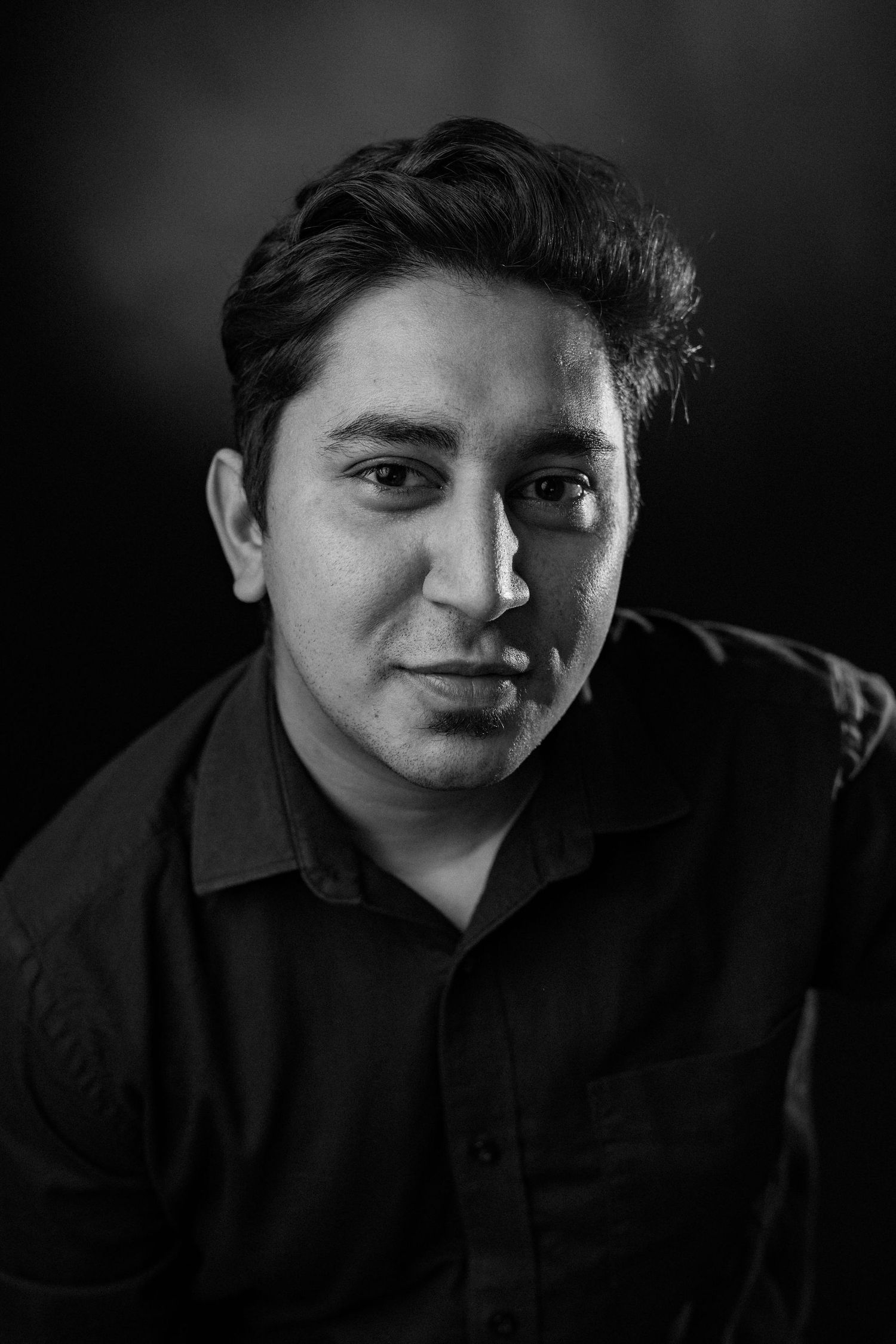 A series of black and white close-up portrait photos showing expressive moods and reactions in dramatic lighting.
