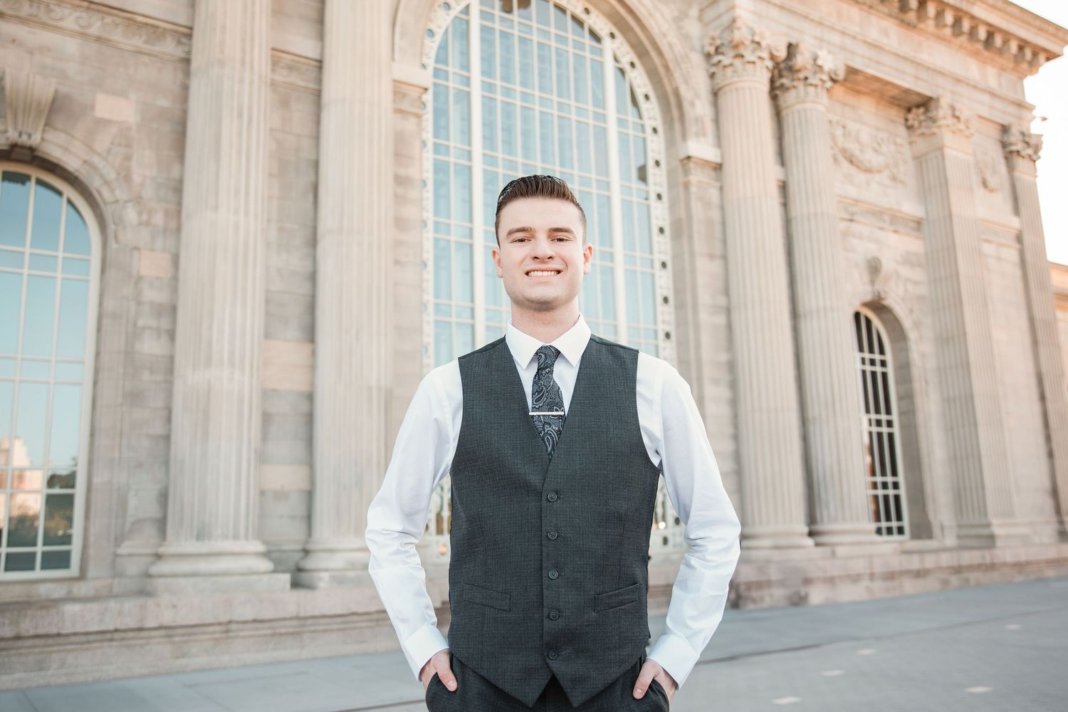 Architectural photo shoot at a grand classical building with ornate stone columns and arches.
