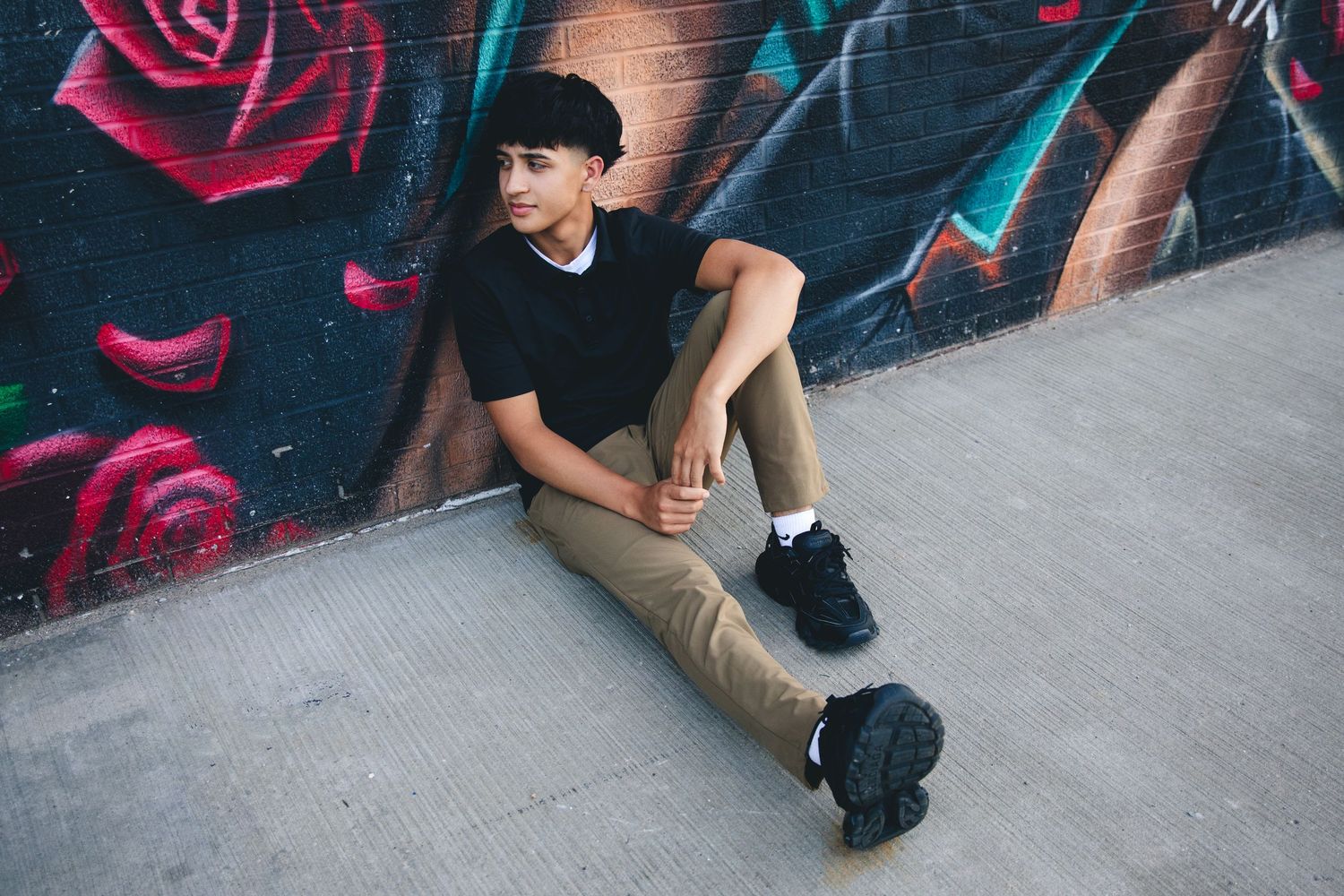 Stylish portrait series against colorful street art with pink and blue graffiti elements.