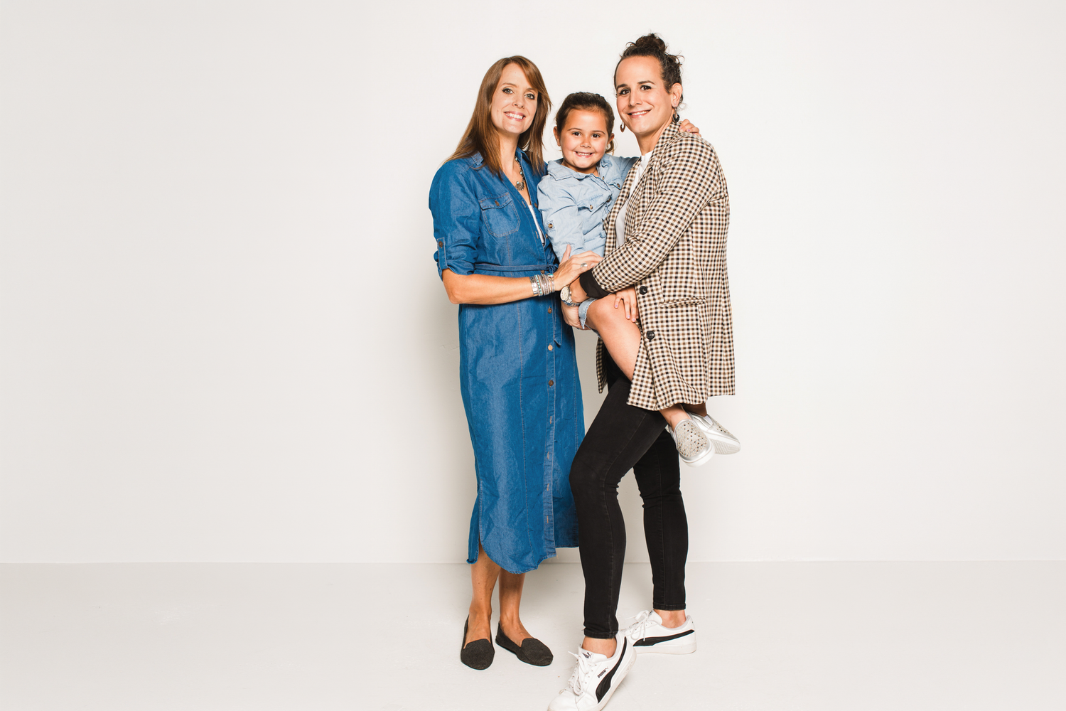 Emily, Don and Frankie Mamone captured by Christa Meola wearing stylish casual outfits, against a white background for our branding session