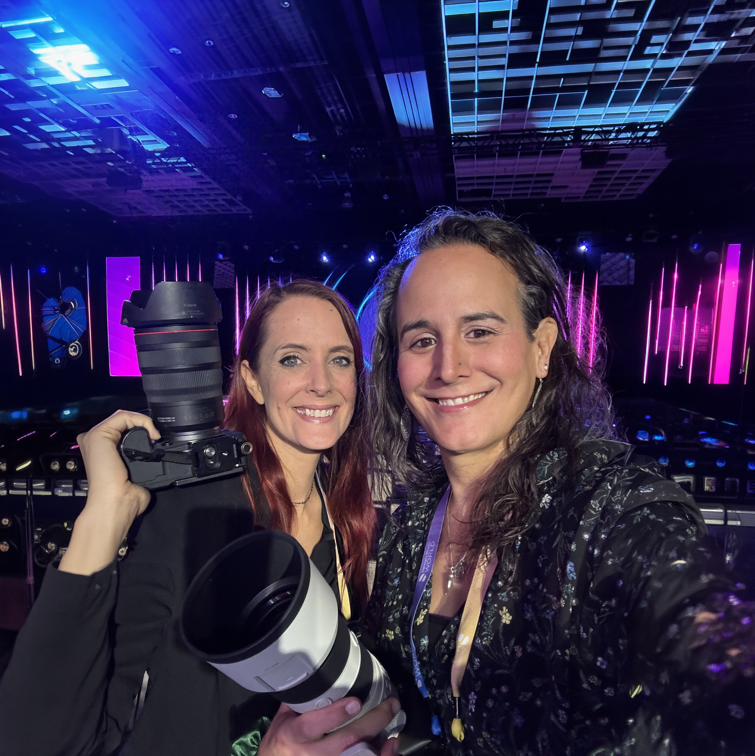 The Mamones smile for a selfie at an event in Las Vegas holding a canon camera with a 24-70 and a sony with a 70-200 lens