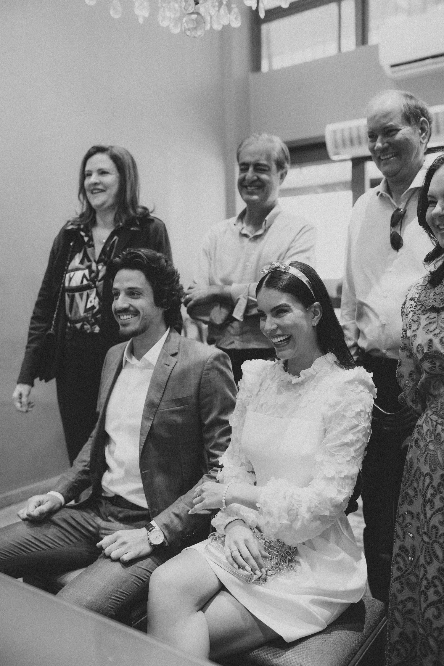 Small gathering of people smiling during intimate indoor celebration.