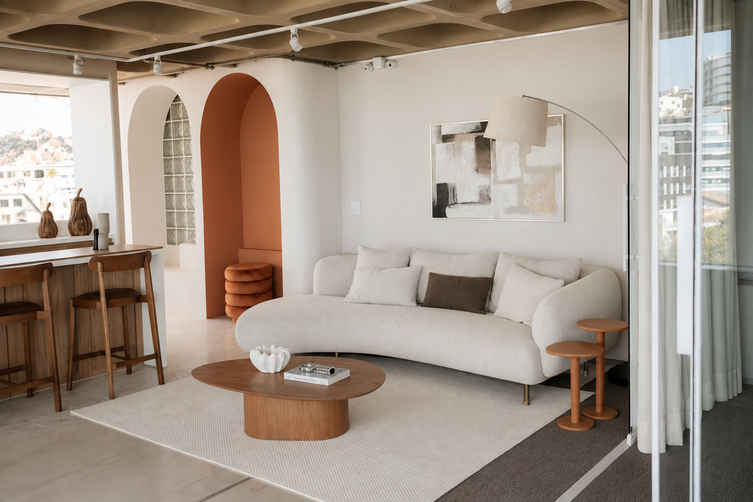 Modern living room with white sofa, terracotta arch, oval wood coffee table, and minimalist decor in neutral tones.