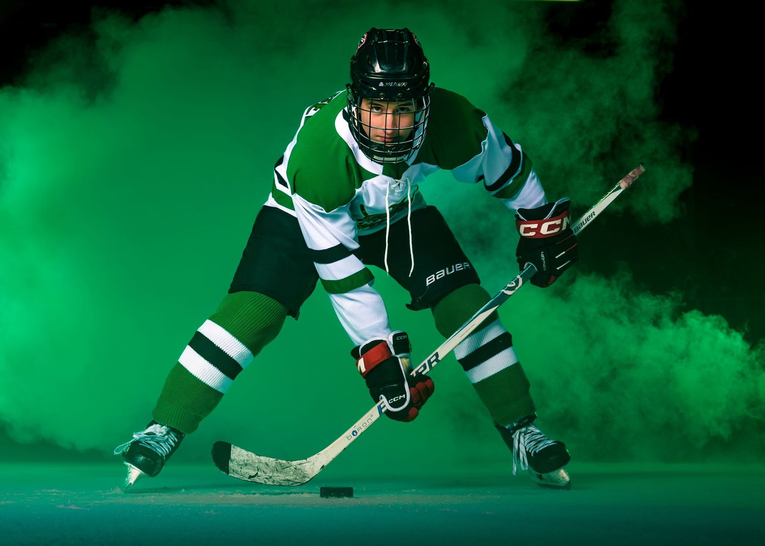 High school hockey player Media Day portrait with green smoke effects, by Deanna Fox, SportsFox Photography, Hershey PA