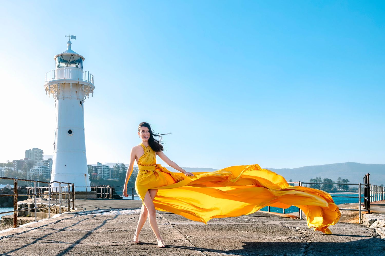 Creative coastal portrait in a flying dress photographed in Wollongong.