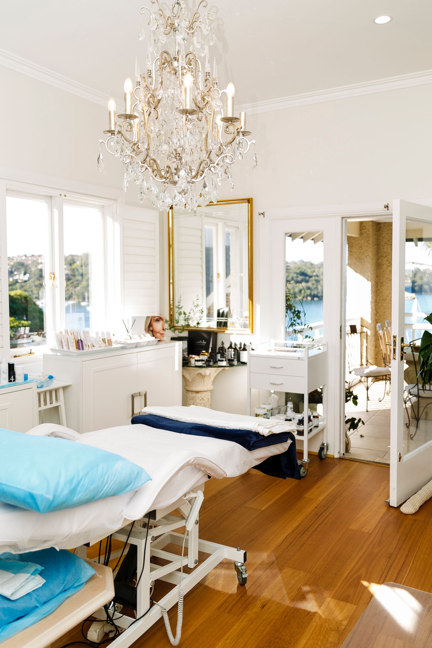 Elegant beauty salon treatment room with crystal chandelier and massage table. Wollongong Corporate Branding Photographer
