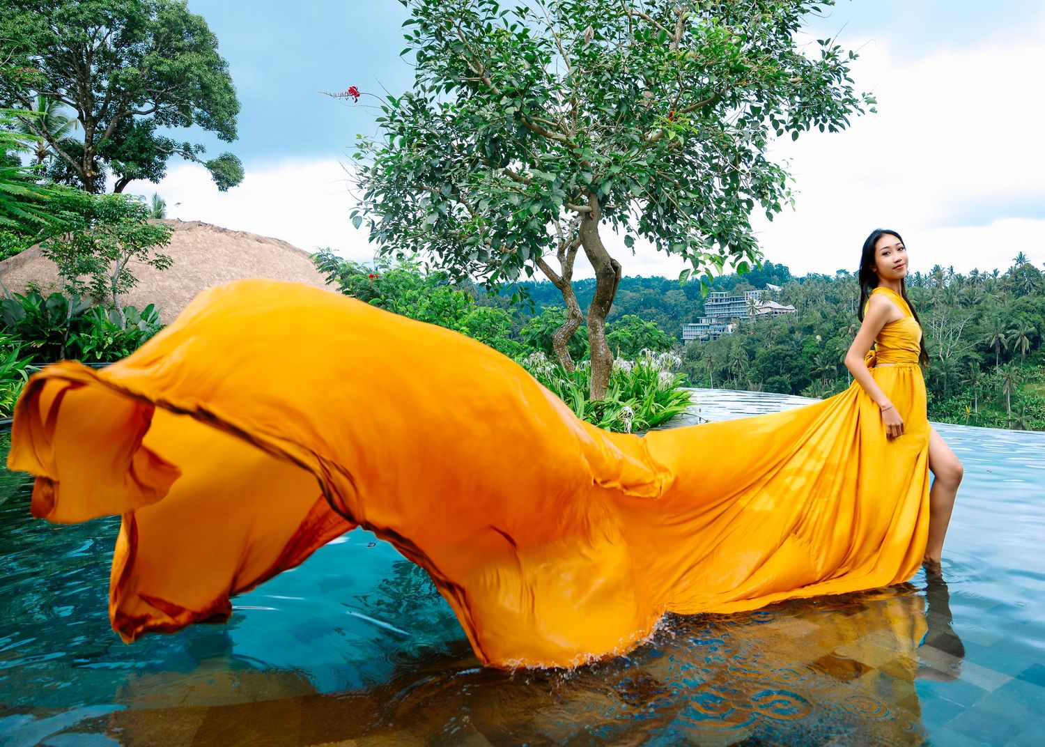 Wollongong Flying Dress Photographer. Girl in yellow Flying Dress in the pool at Akohara Resort Bali.