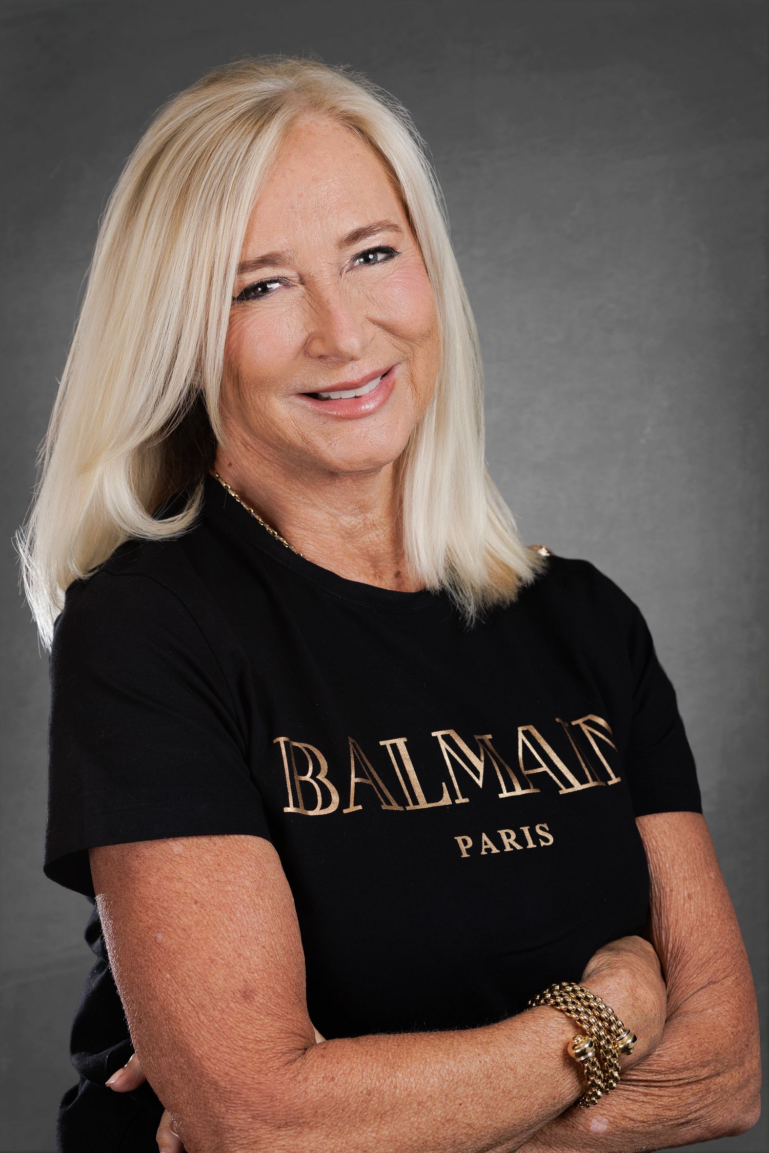 Woman with blonde hair wearing a black Balmain Paris t-shirt. Wollongong Headshot Photographer