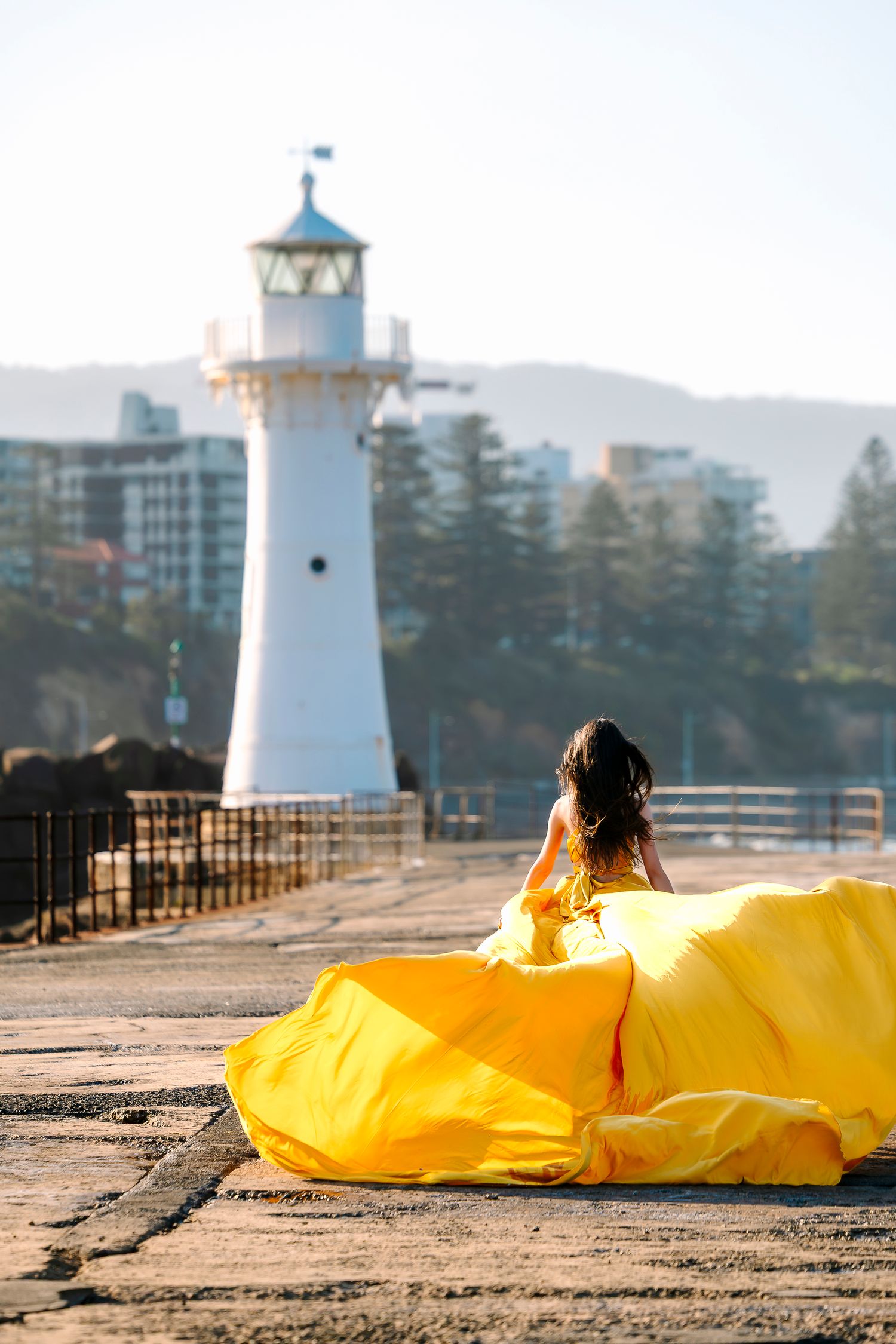 Creative coastal portrait in a flying dress photographed in Wollongong.