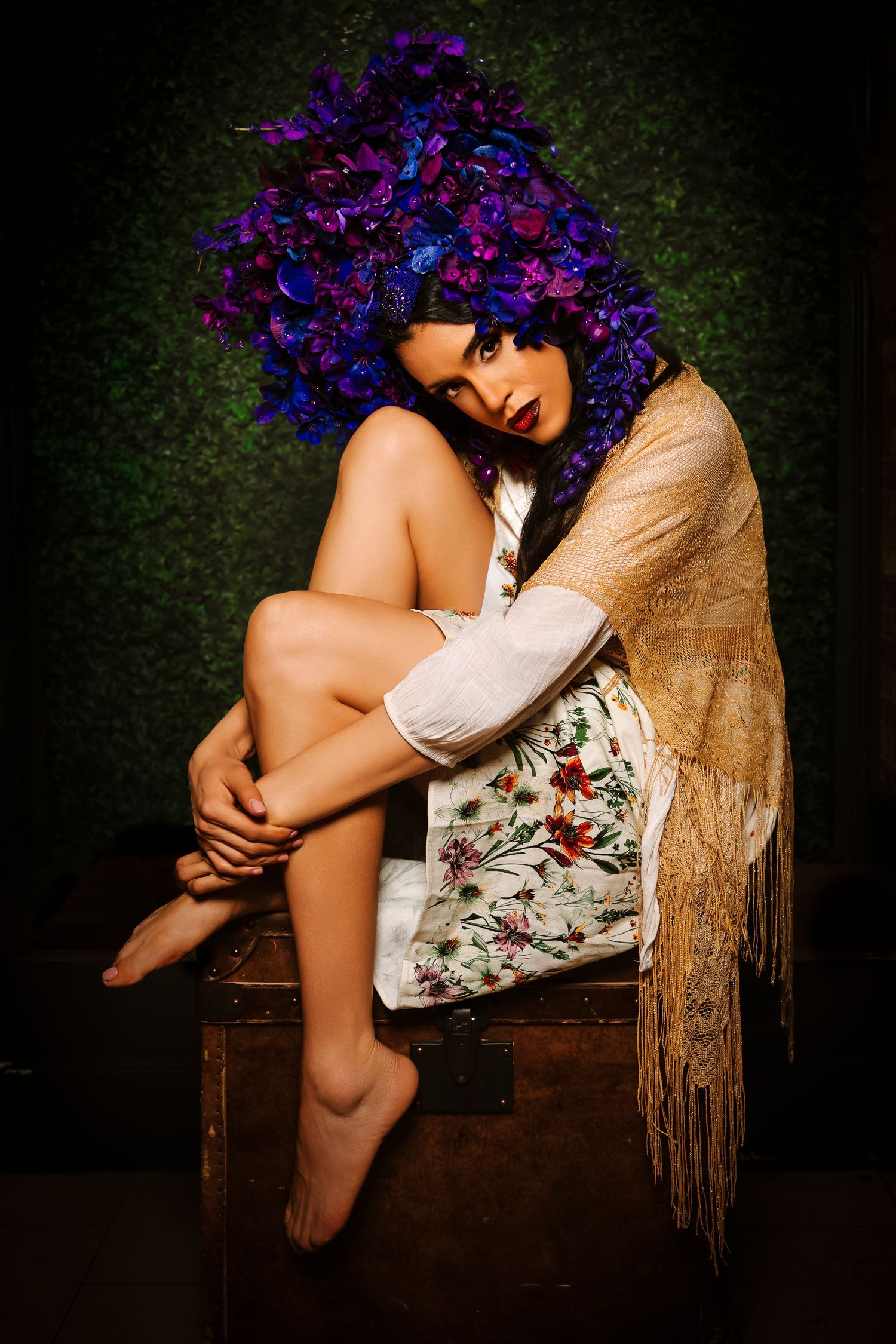 Wollongong Portrait Photographer. Woman in floral headpiece and fringed shawl sits barefoot on vintage trunk.