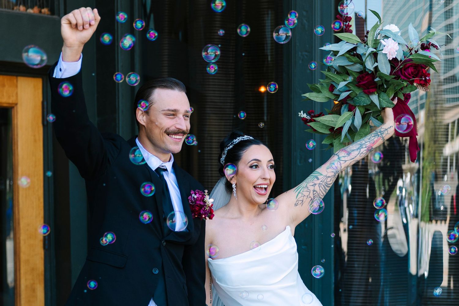 Joyful newlyweds celebrate with bubbles. Wollongong Wedding Photographer