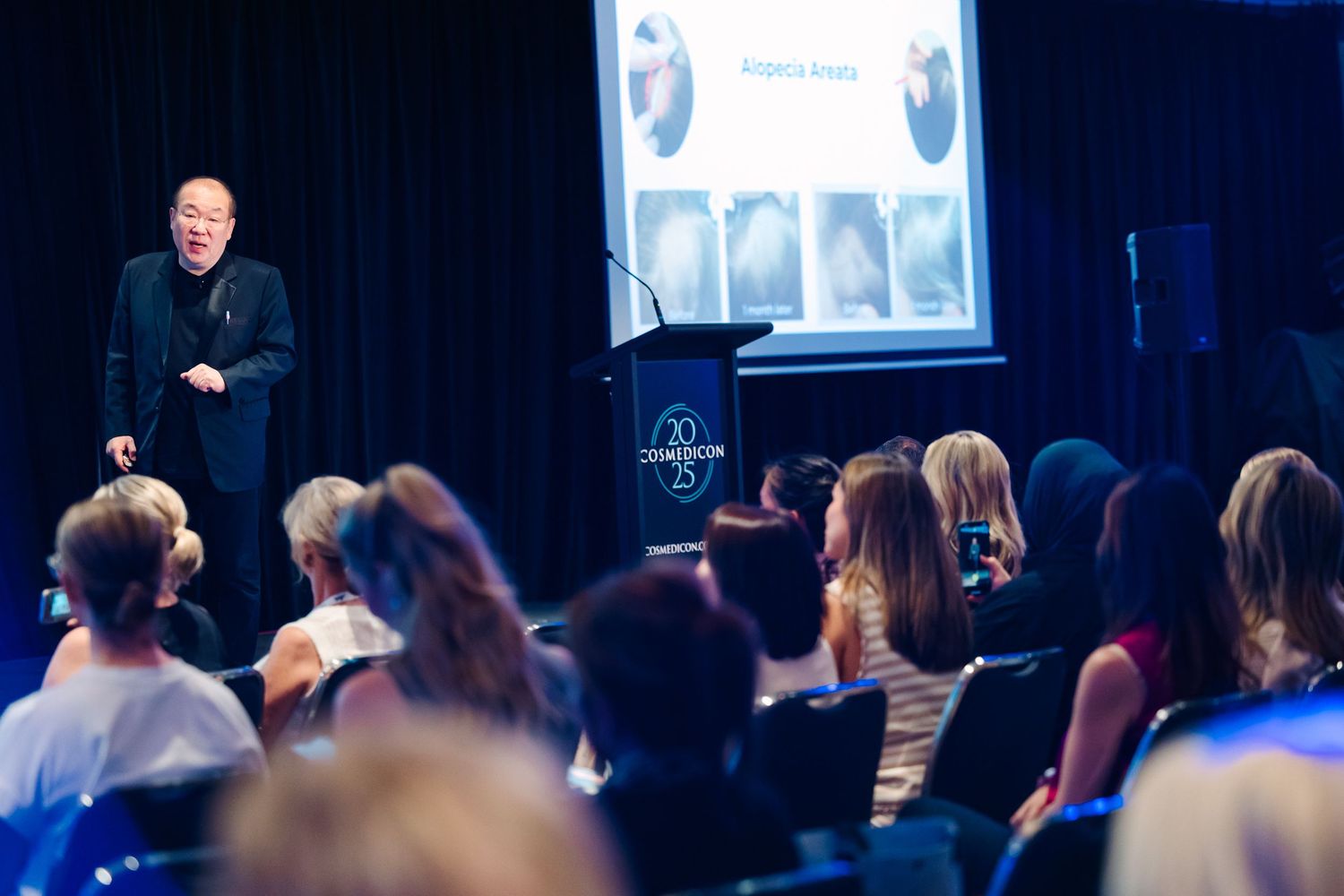 Wollongong Corporate Event Photographer. Speaker presenting to a large audience at a professional conference.
