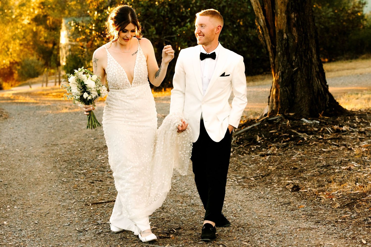 Bride and groom walking hand in hand outdoors at sunset. Wollongong Wedding Photographer