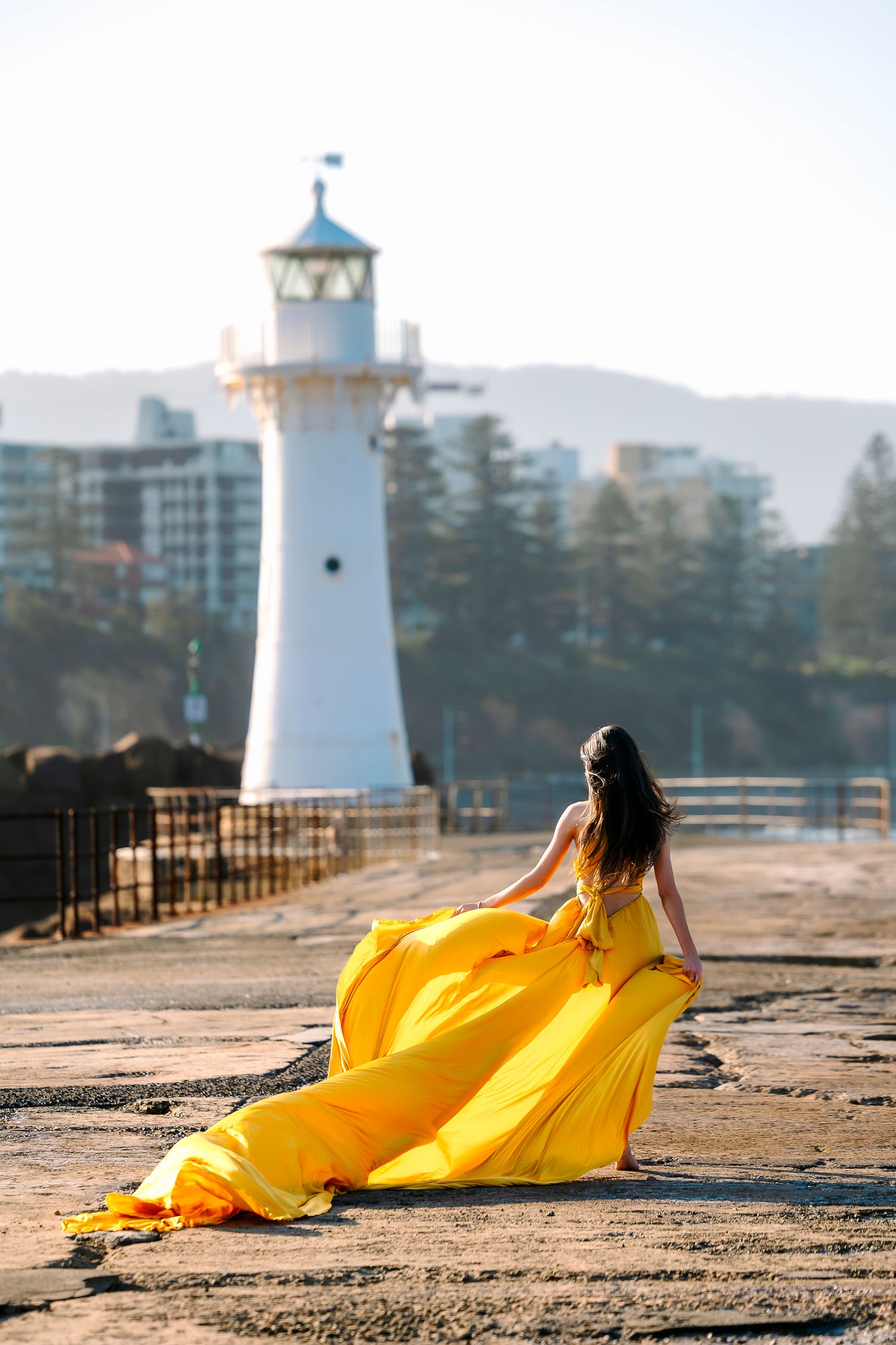 Creative coastal portrait in a flying dress photographed in Wollongong.