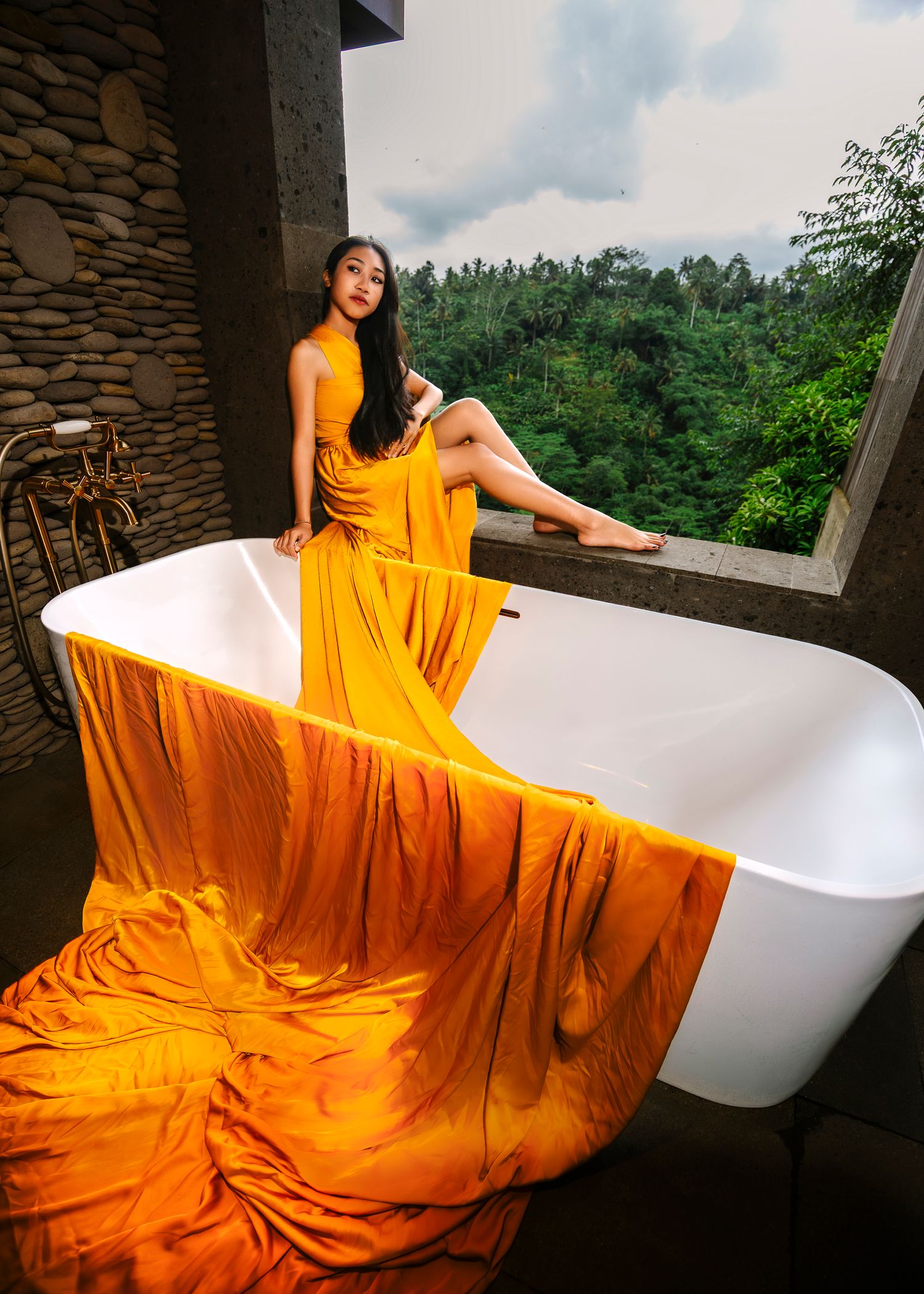 Wollongong Flying Dress Photographer. Girl in yellow Flying Dress sitting in the bathroom window at Akohara Resort Bali.