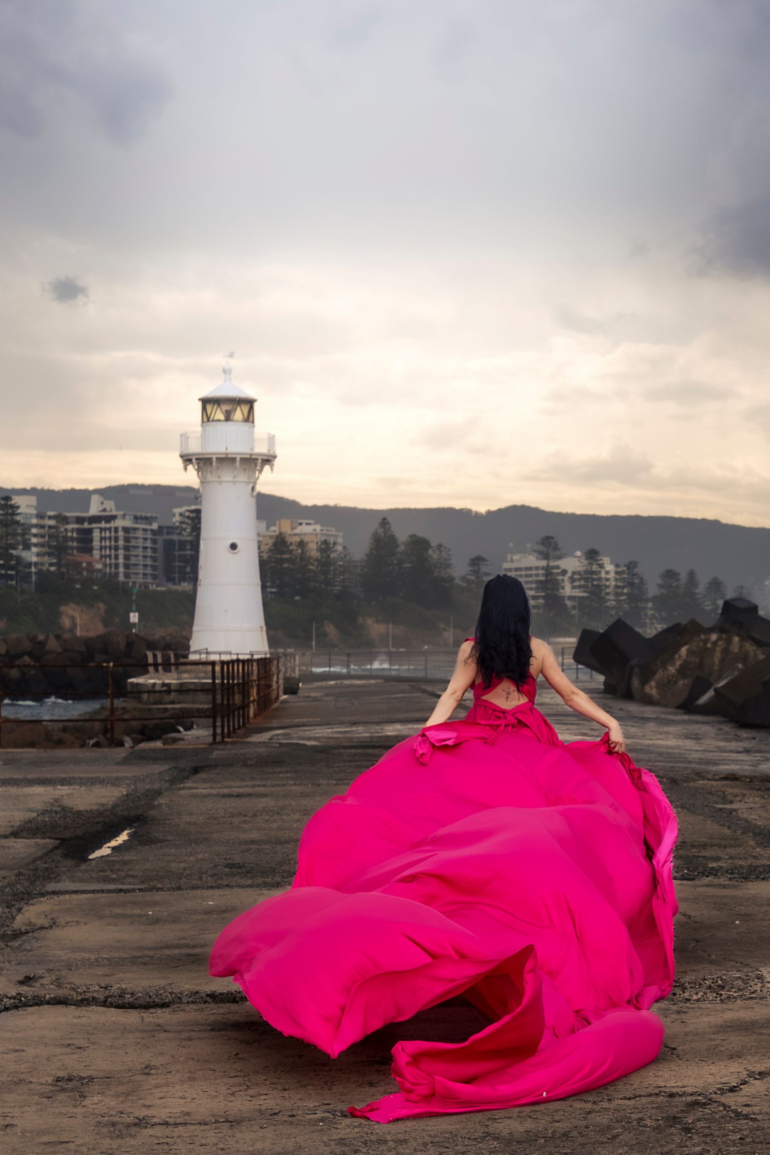 Creative coastal portrait in a flying dress photographed in Wollongong.
