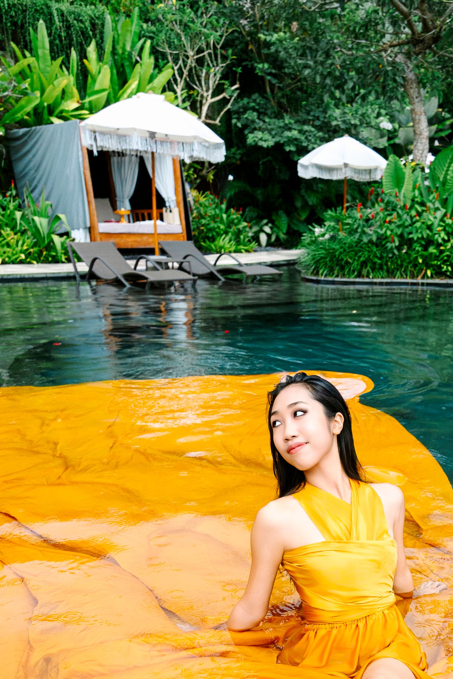 Wollongong Flying Dress Photographer. Girl in yellow Flying Dress in the pool at Akohara Resort Bali.