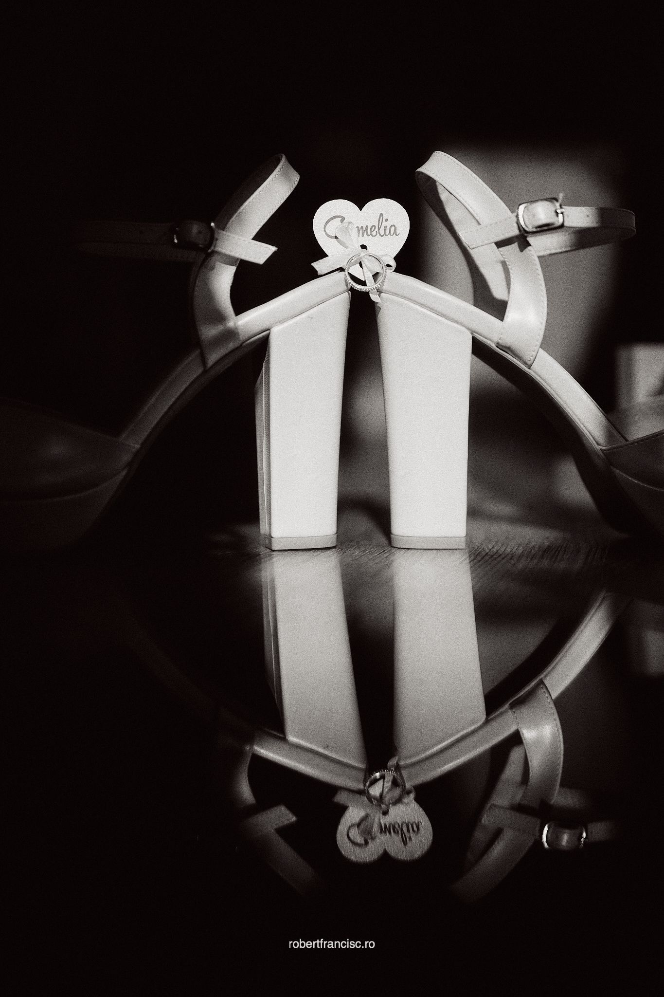 Black and white artistic series showing abstract paper cutouts forming heart shapes against dark backgrounds.