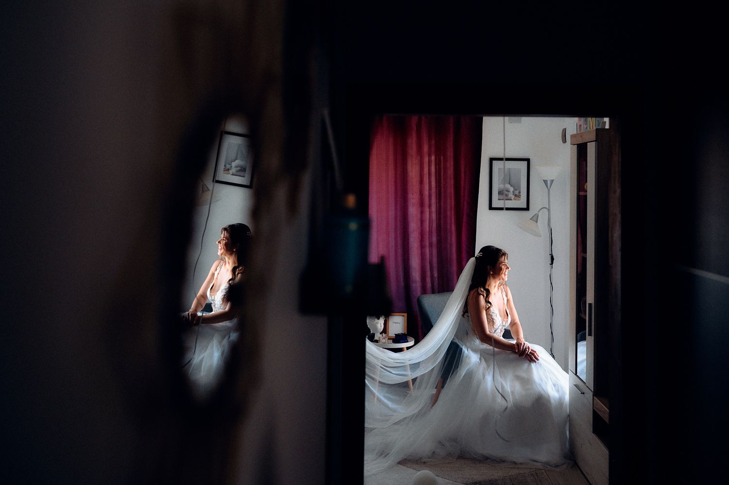 Creative mirror reflection shot of wedding preparation showing a dress in multiple angles.
