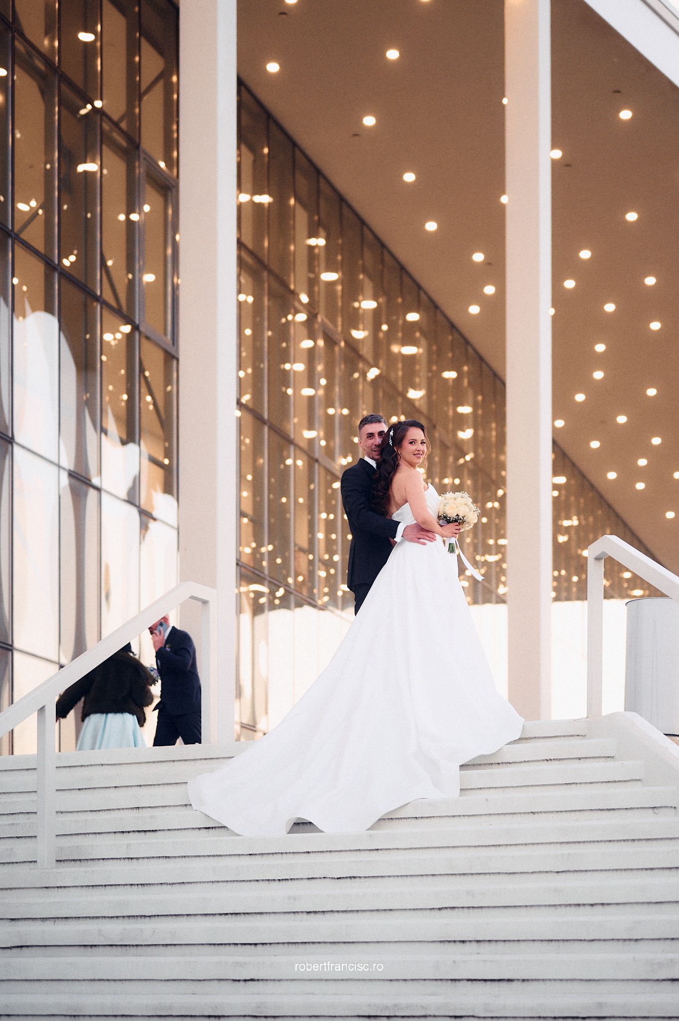 A sequence of wedding photos capturing a bride's dress flowing gracefully as she spins on architectural steps.