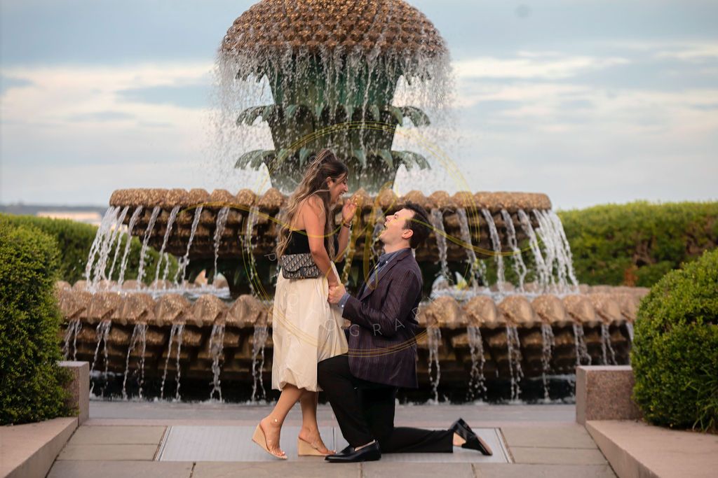 Couple's romantic marriage proposal in front of the iconic Pineapple Fountain at Waterfront Park in Charleston, SC.