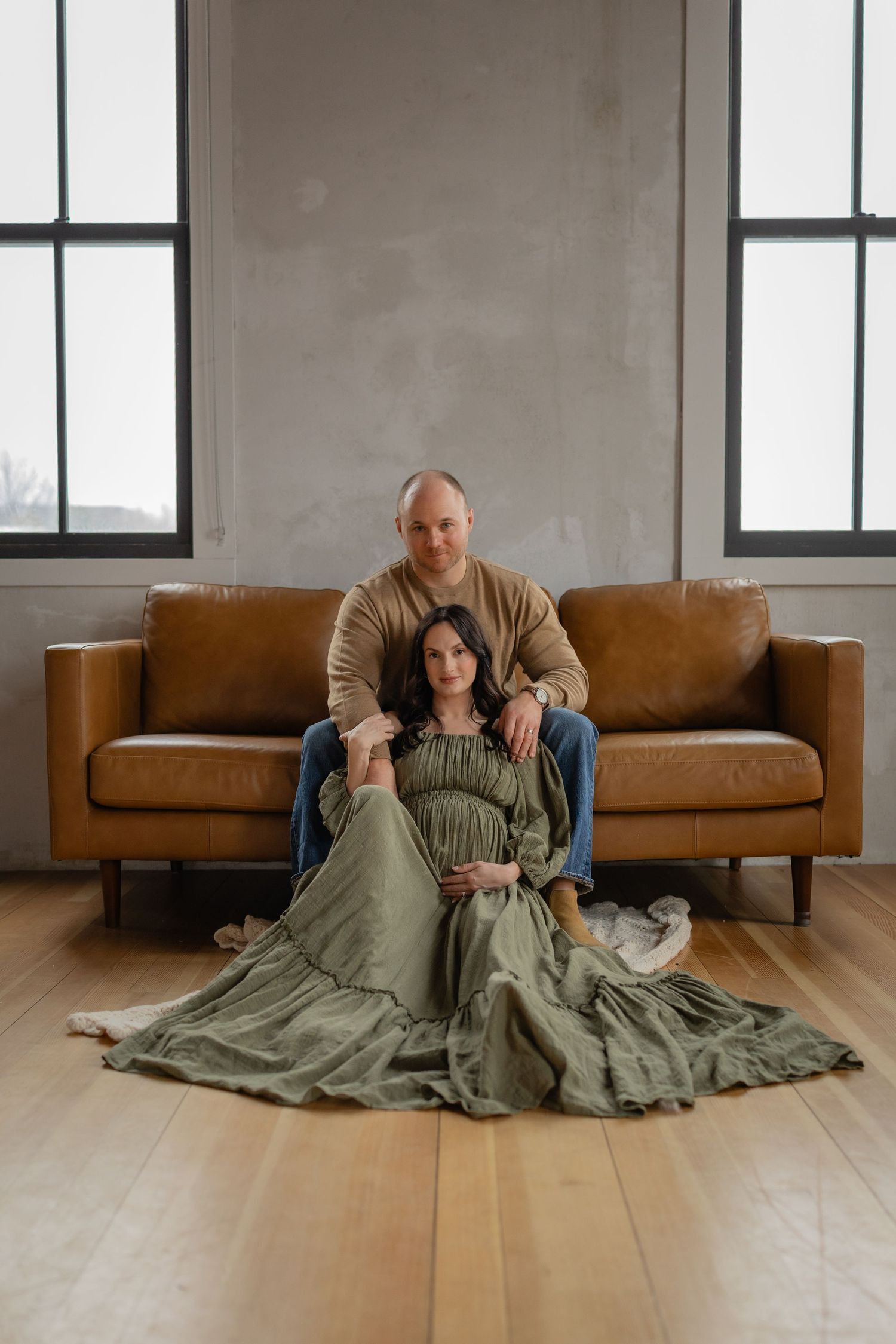 Pregnant woman and partner in a Des Moines studio during lifestyle maternity photo session.