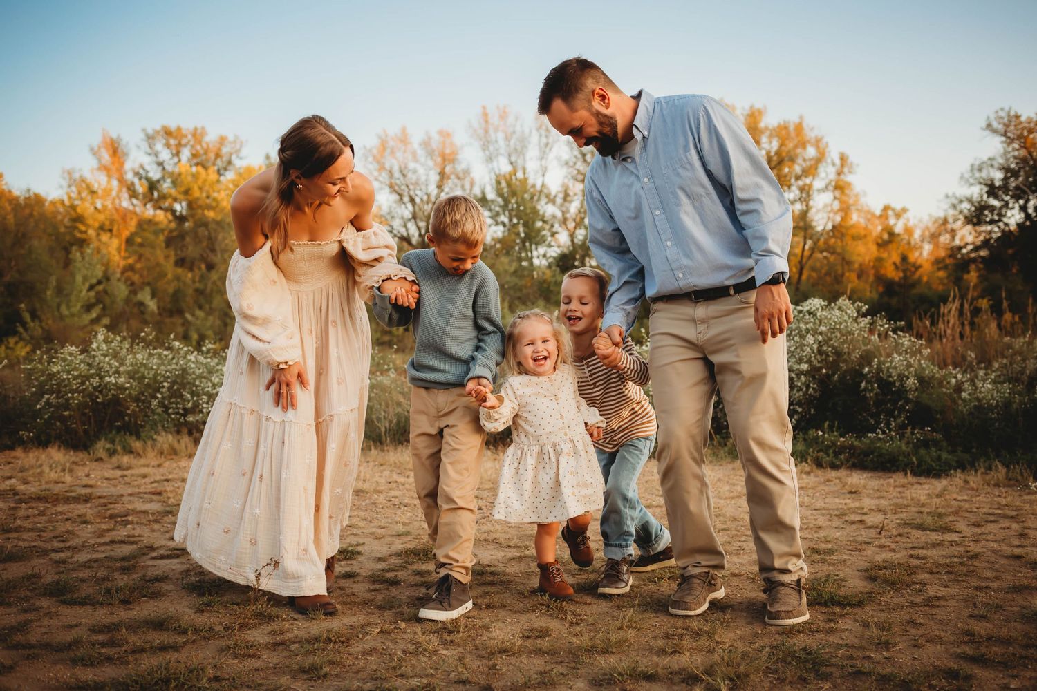Family laughs together in a Des Moines area park during a lifestyle family session.
