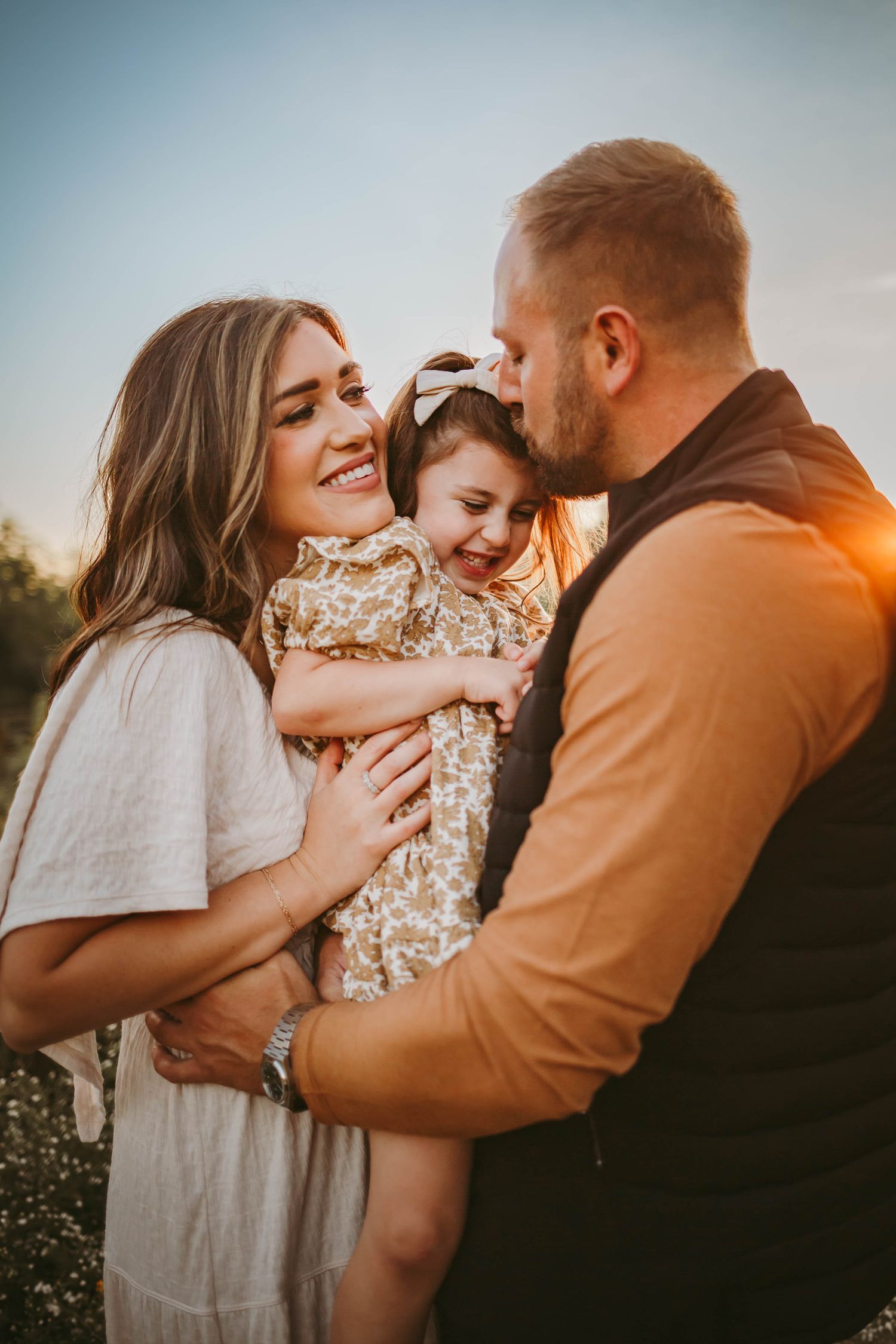 Family embraces in a Des Moines area park during a lifestyle family photo session.