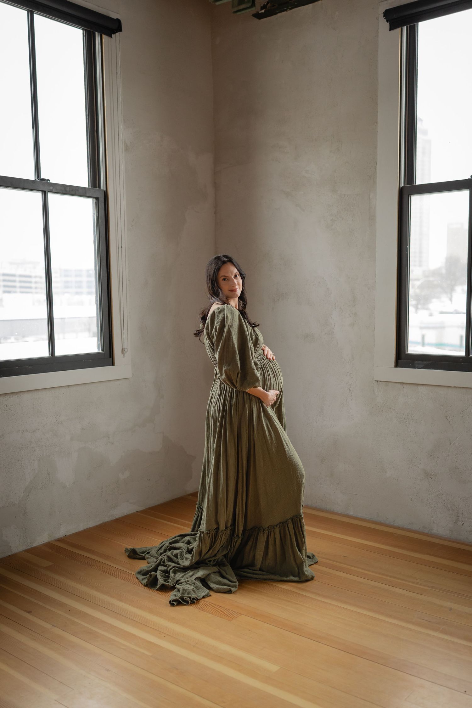 Pregnant woman in a Des Moines studio during lifestyle maternity photo session.