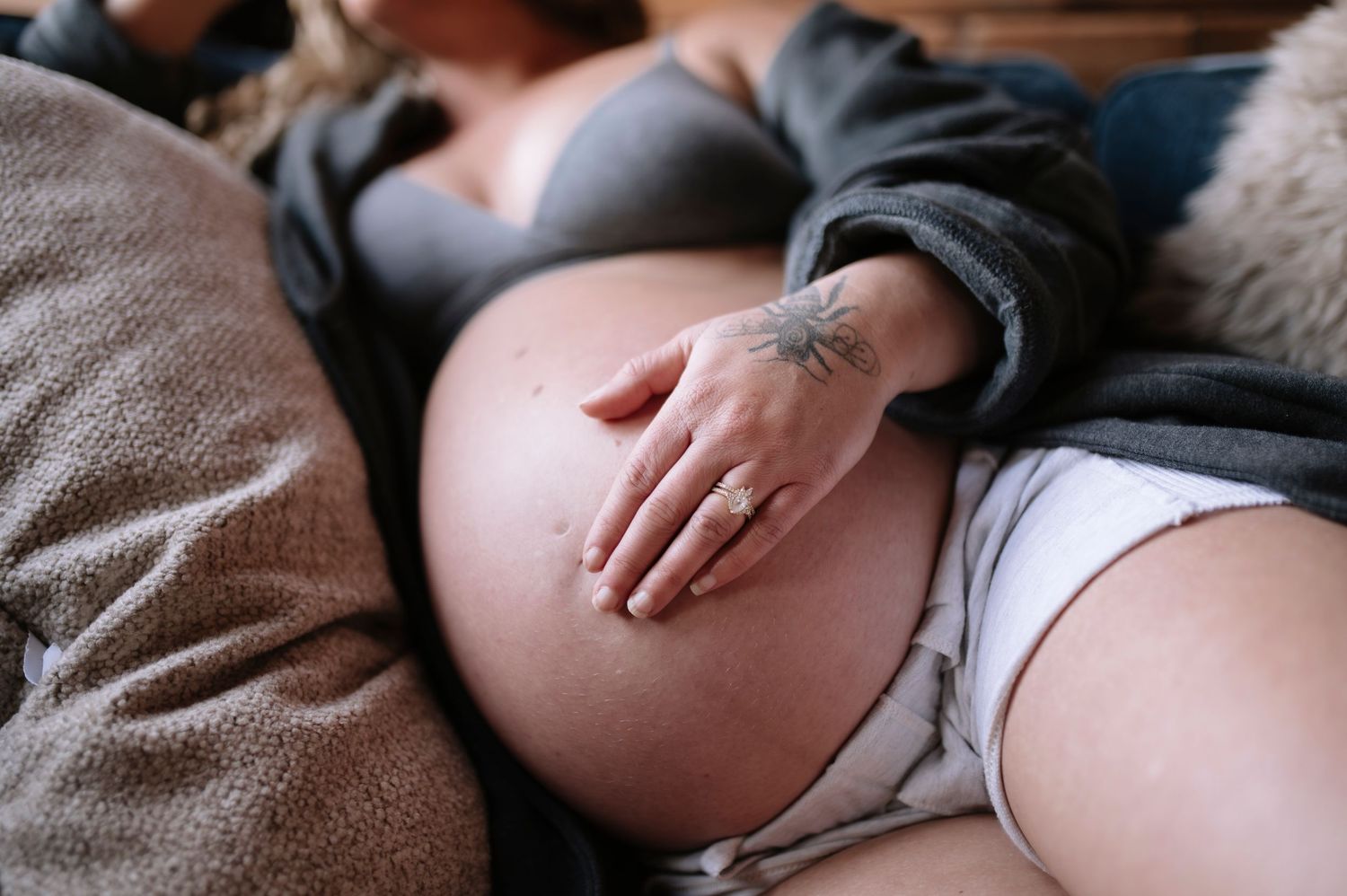 A close-up series of maternity photos showing a pregnant woman's belly being held by gentle hands.