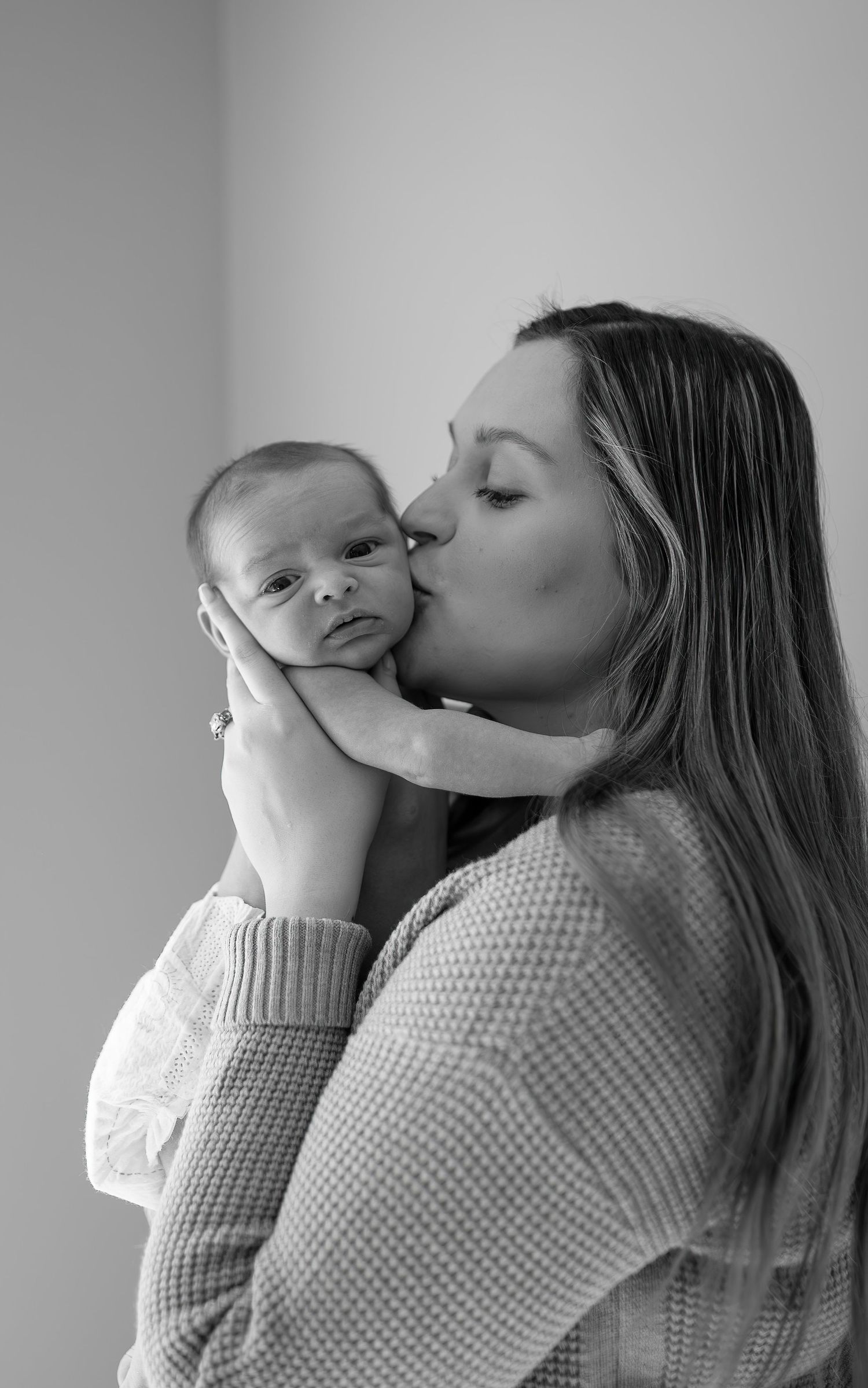An intimate black and white portrait of parent and baby.