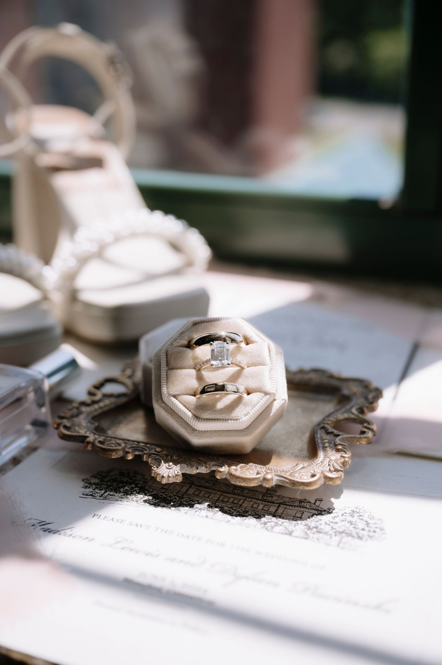 A series of macro photos showing jewelry casting process with metal rings and stones in white molds on a bright surface.