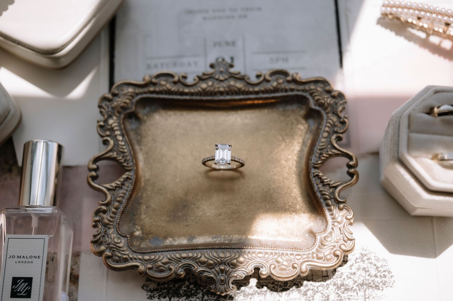 A collection of vintage-style ornate frames and decorative elements arranged on a white wall.