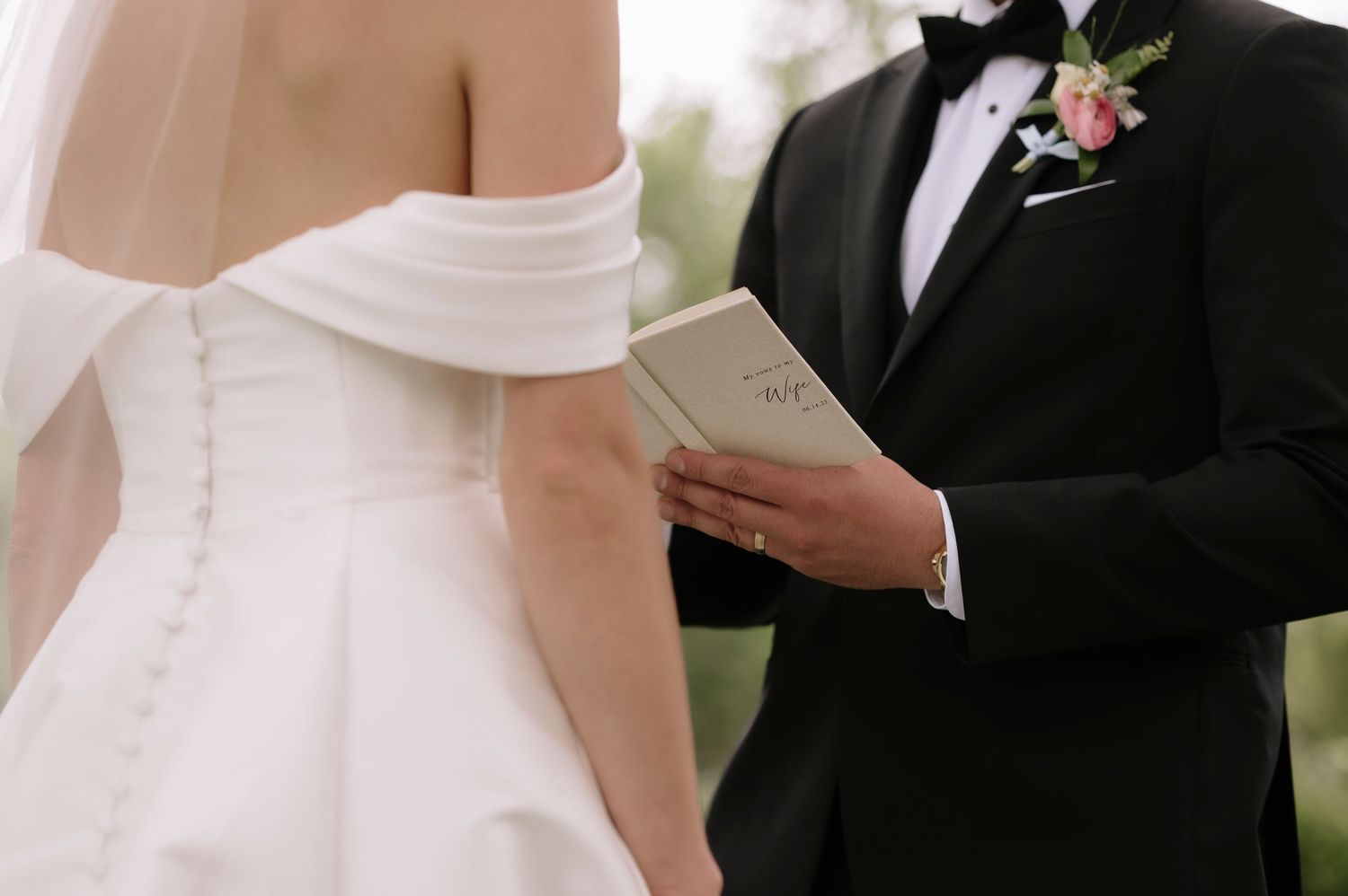 Bride and groom share an intimate moment during their wedding ceremony while reading from papers.