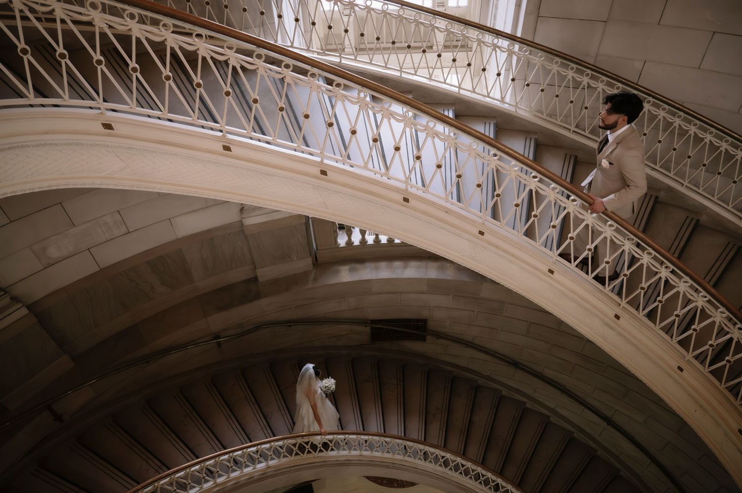 Architectural detail of ornate arched ceiling with intricate lattice metalwork and decorative moldings in a historic building.
