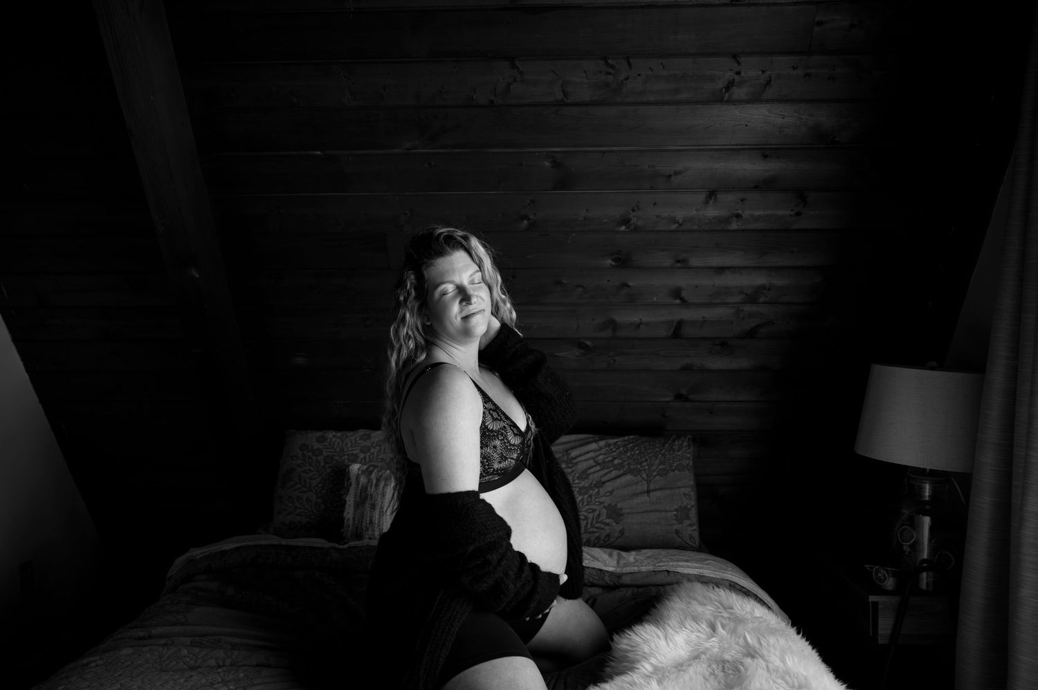A series of black and white boudoir photos showing intimate moments in a rustic wooden setting.