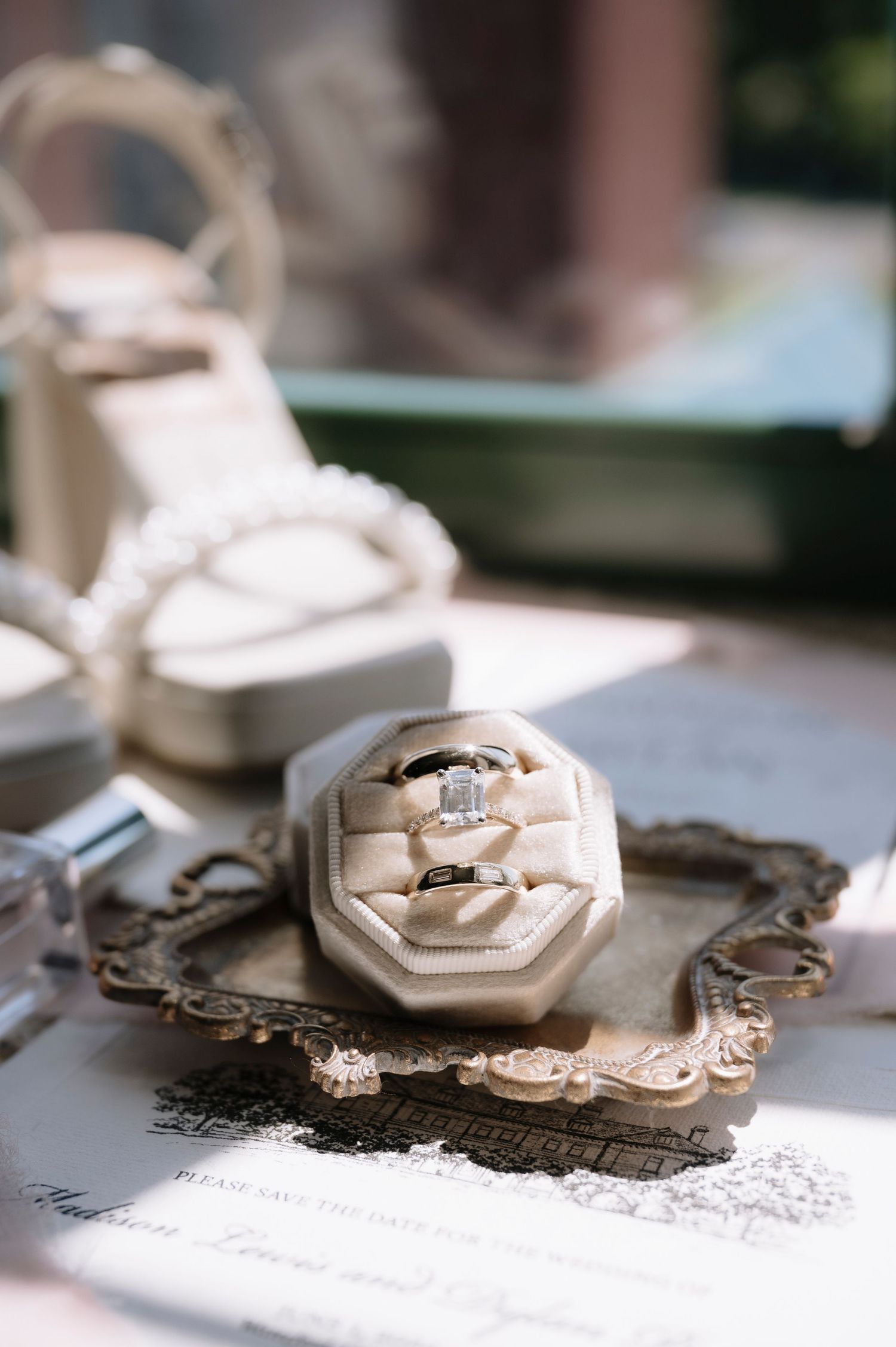 A series of vintage Art Deco style lockets or jewelry pieces shown in close-up detail against a light background.