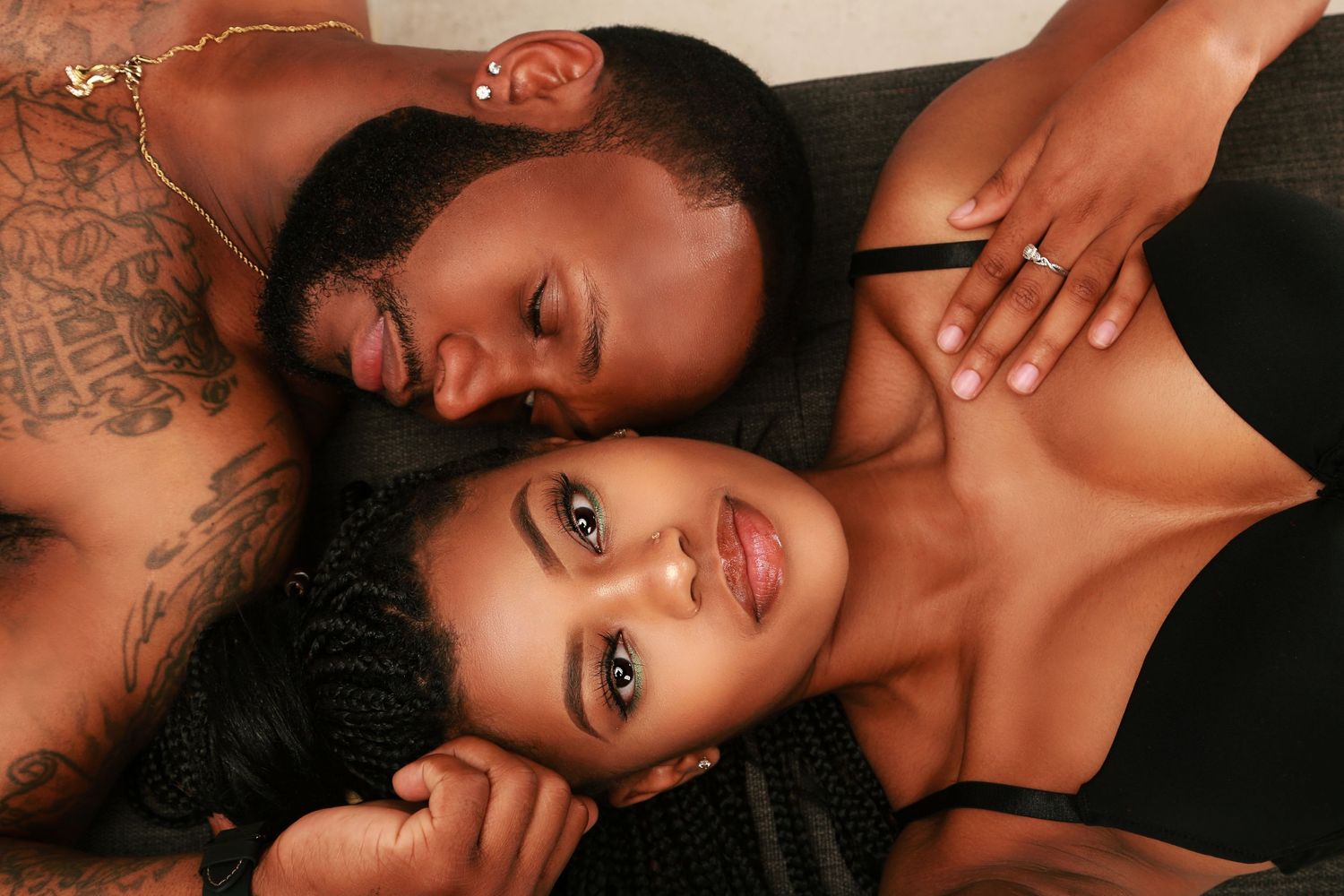 Intimate close-up portrait of couple in black outfits.