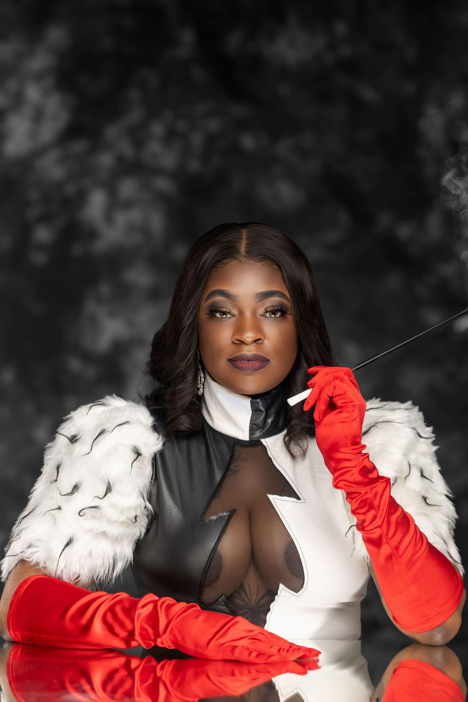 Glamorous portrait featuring white fur coat and red gloves against dark background.