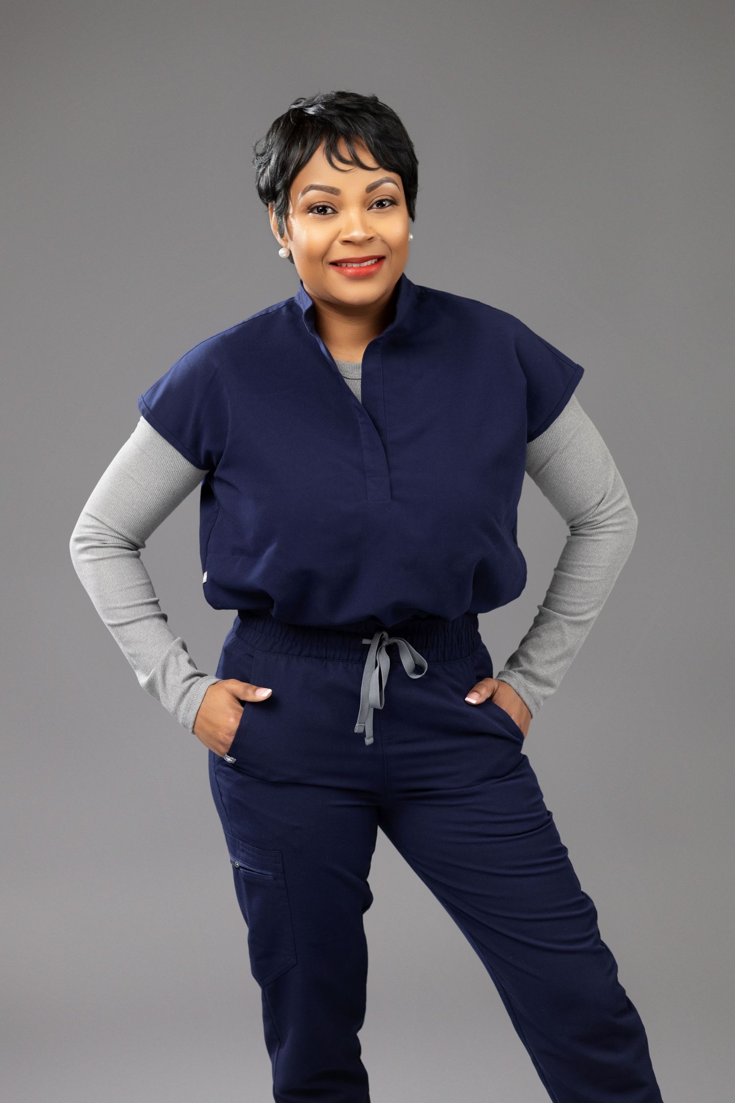 Athletic wear ensemble featuring a navy blue and gray color-blocked top with matching drawstring pants.