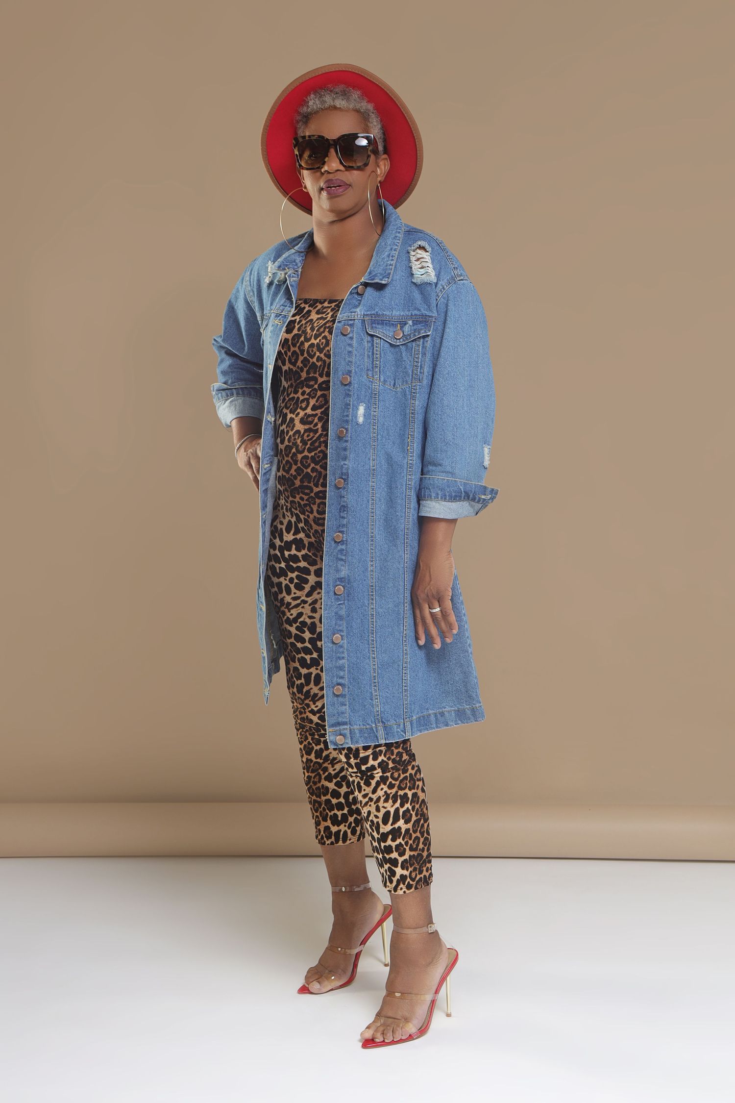 Stylish outfit featuring denim coat, leopard print jumpsuit and red beret.