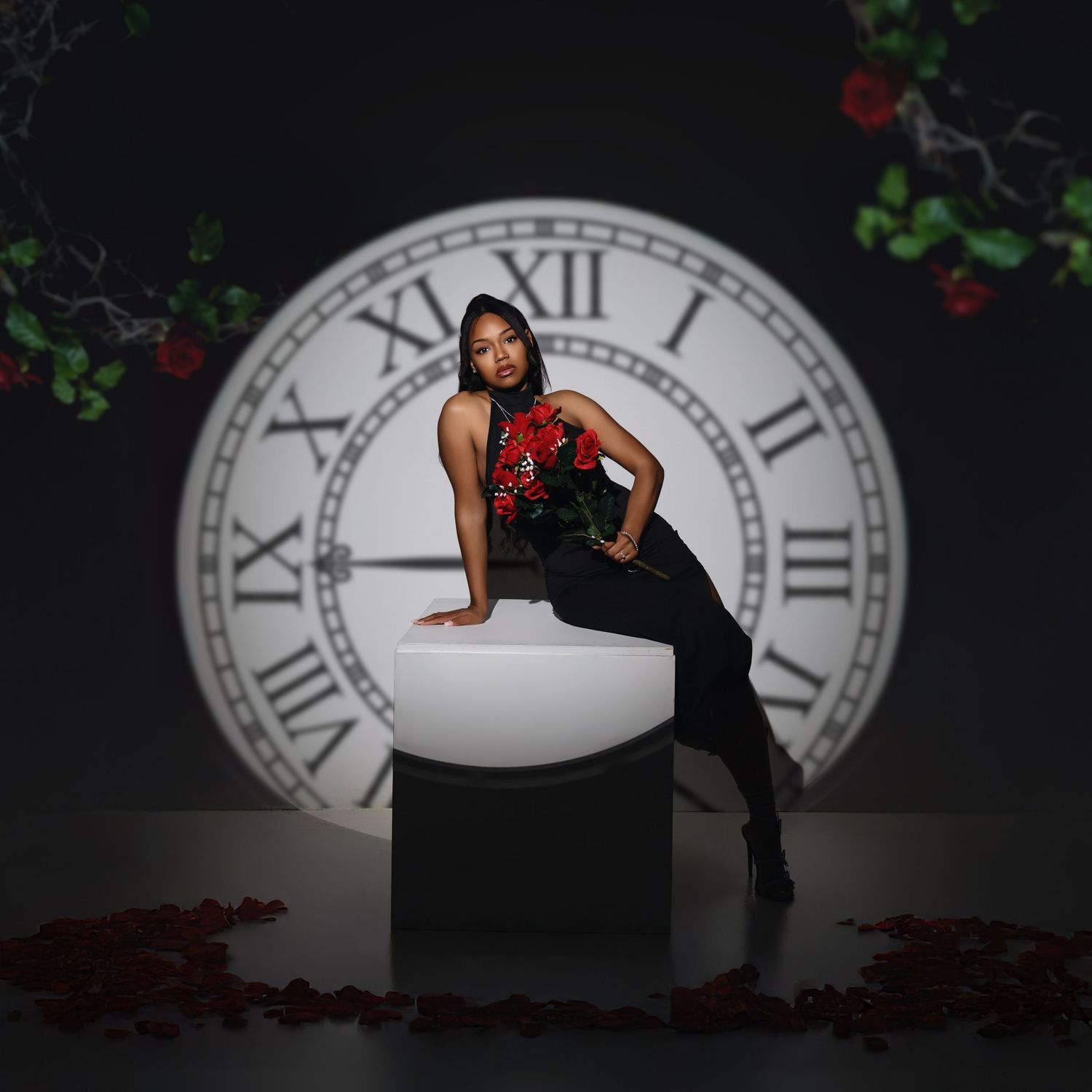 Dramatic portrait with large clock backdrop featuring elegant red and black evening wear.