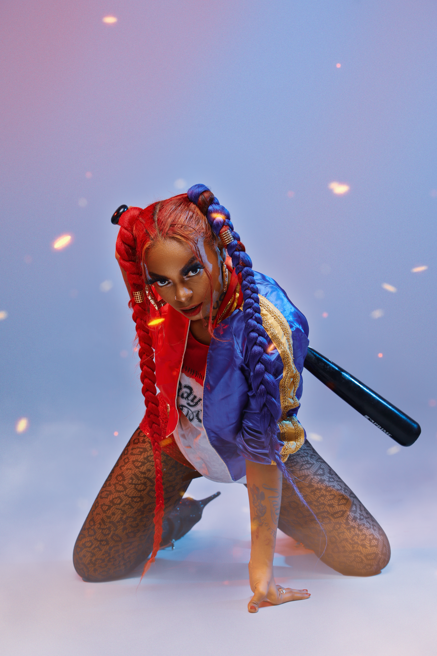 Cosplay inspired portrait in red and blue jacket with braids against ethereal background.