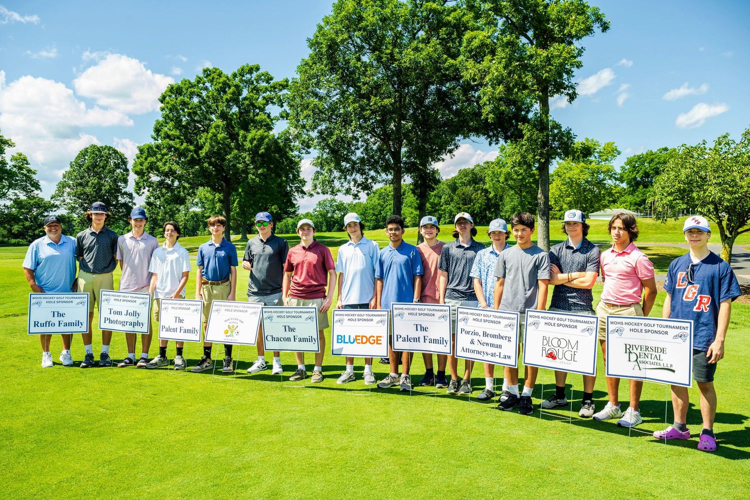 West Orange hockey players with signs of sponsors for golf tournament at Rock Spring Golf Club.