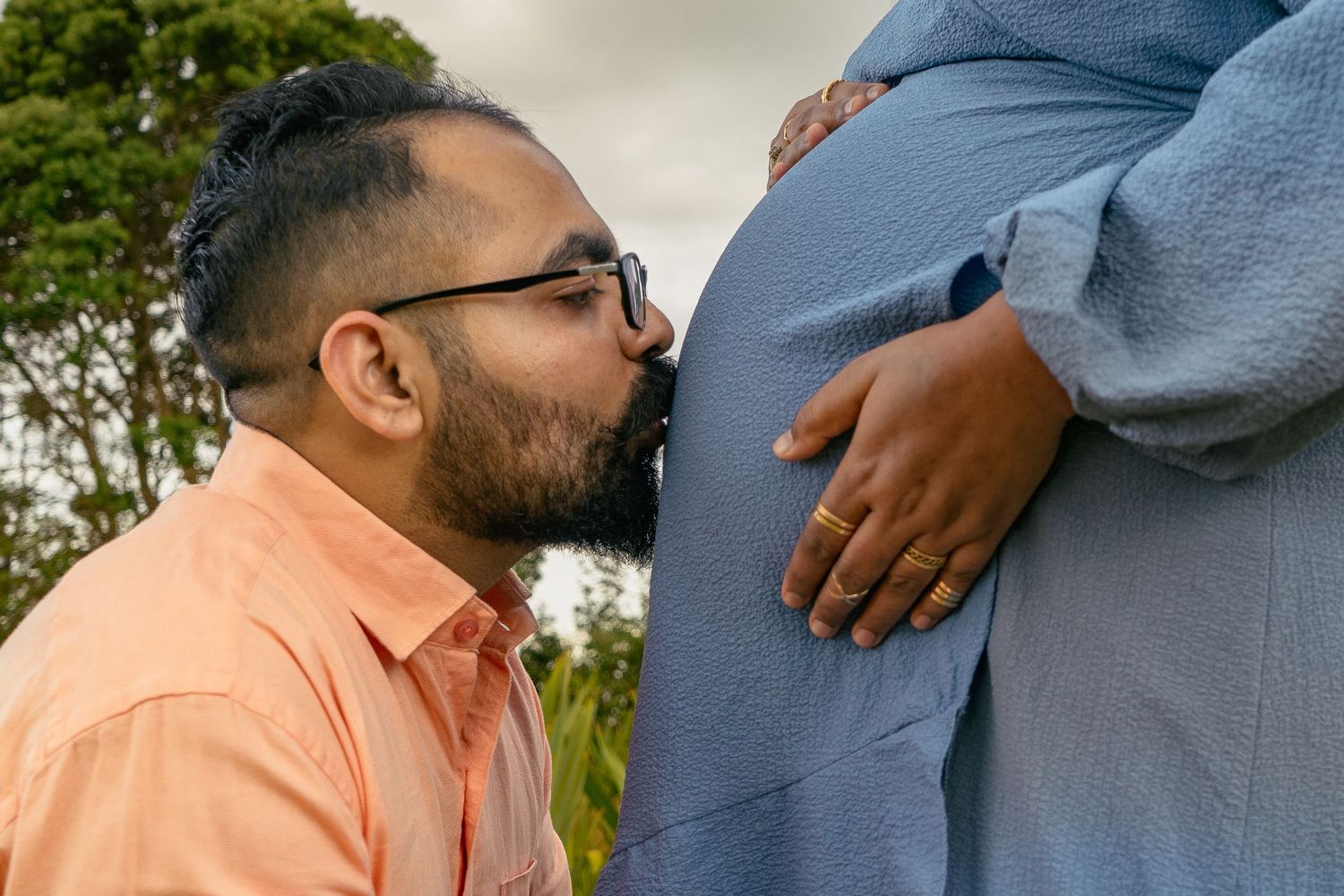 A gorgeous maternity shoot during sunset at Long Bay Beach, Auckland by YM Photography. White, flowy maternity dress used from Shein.