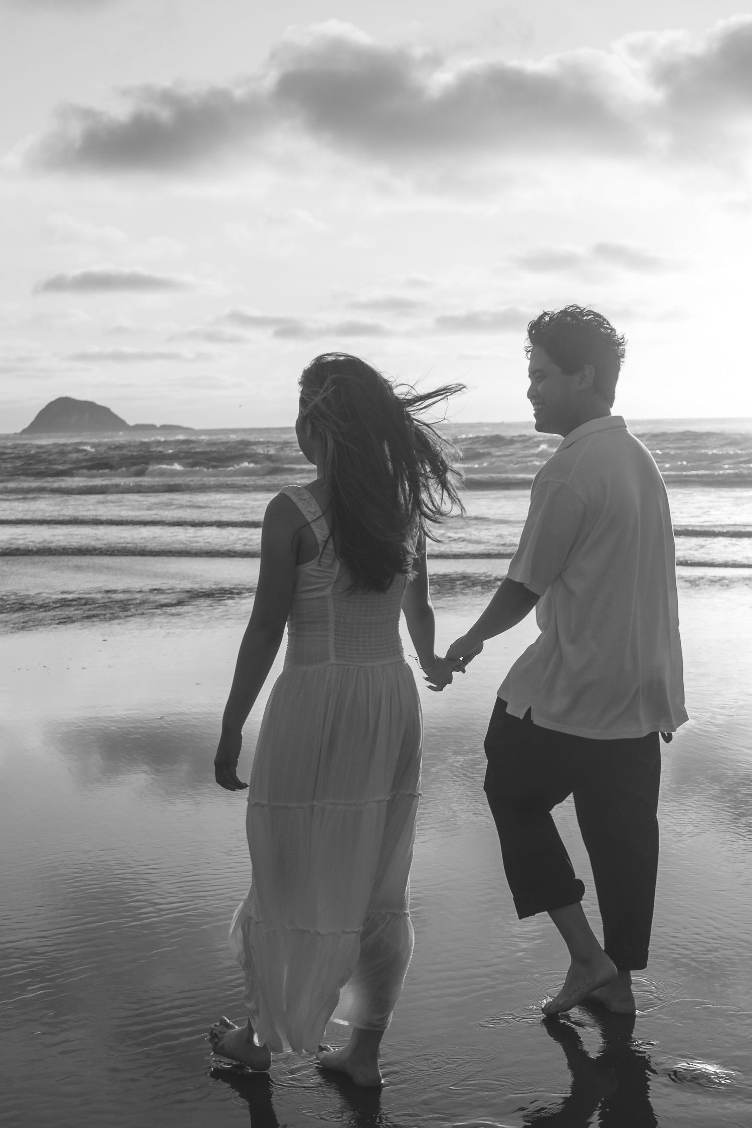 A couple photoshoot session during a magical sunset at Muriwai Beach by YM Photography.