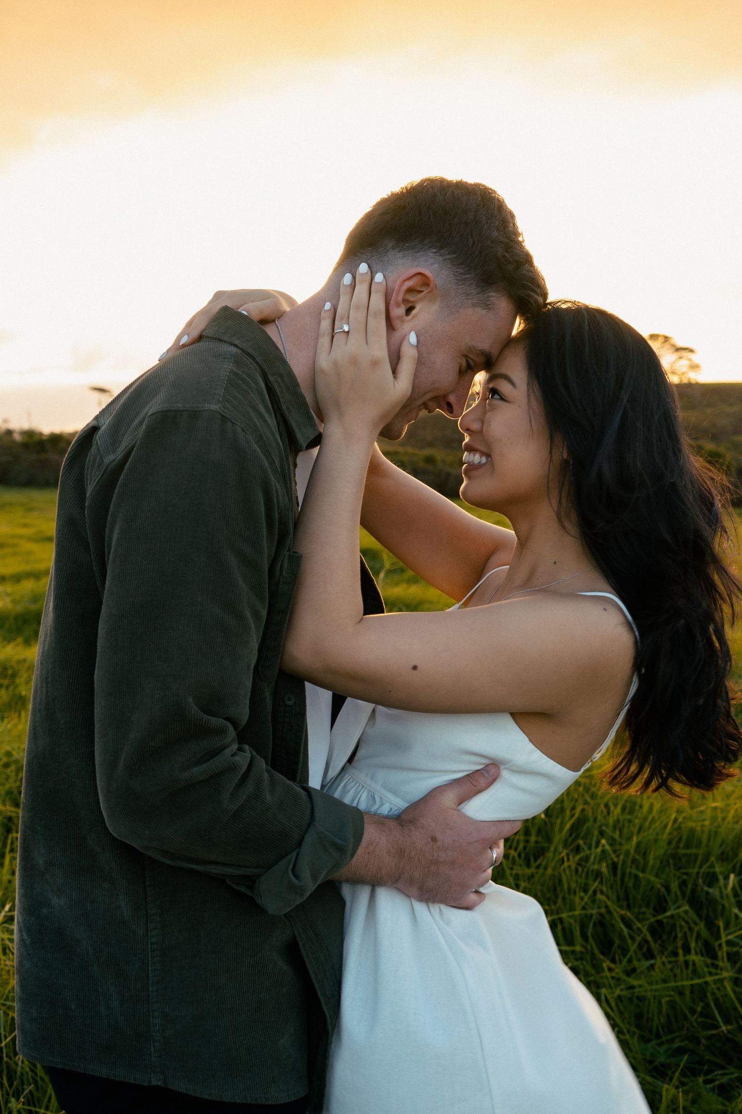 A sweet and romantic proposal at Granny's Bay, Auckland shot by YM Photography, A beautiful engagement session for the couple as well.