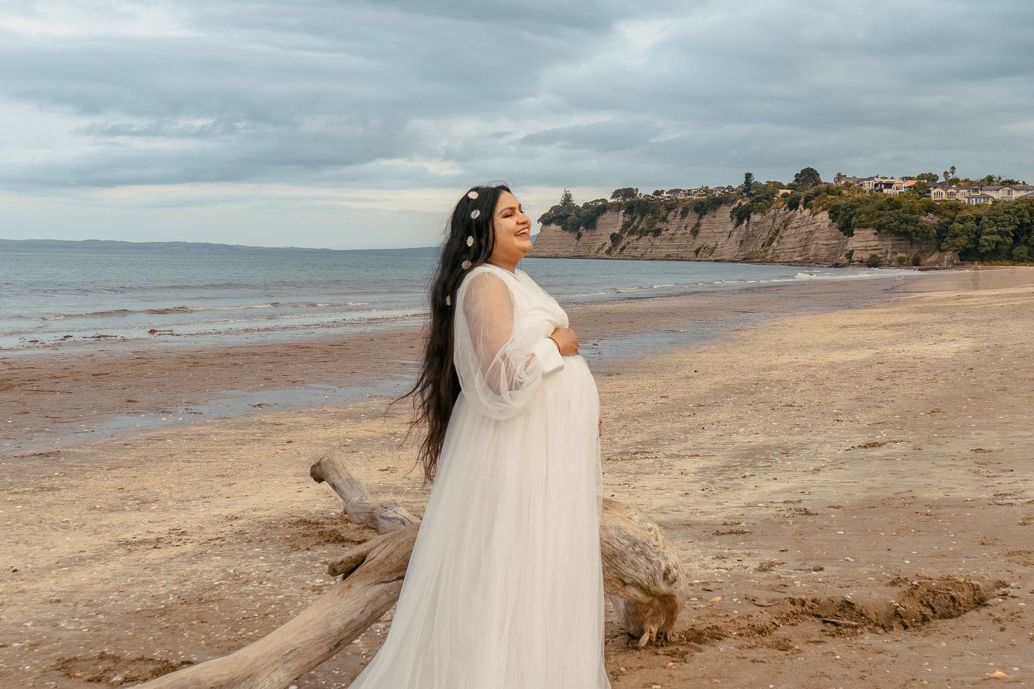 A magical maternity shoot during sunset at Long Bay Beach, Auckland.